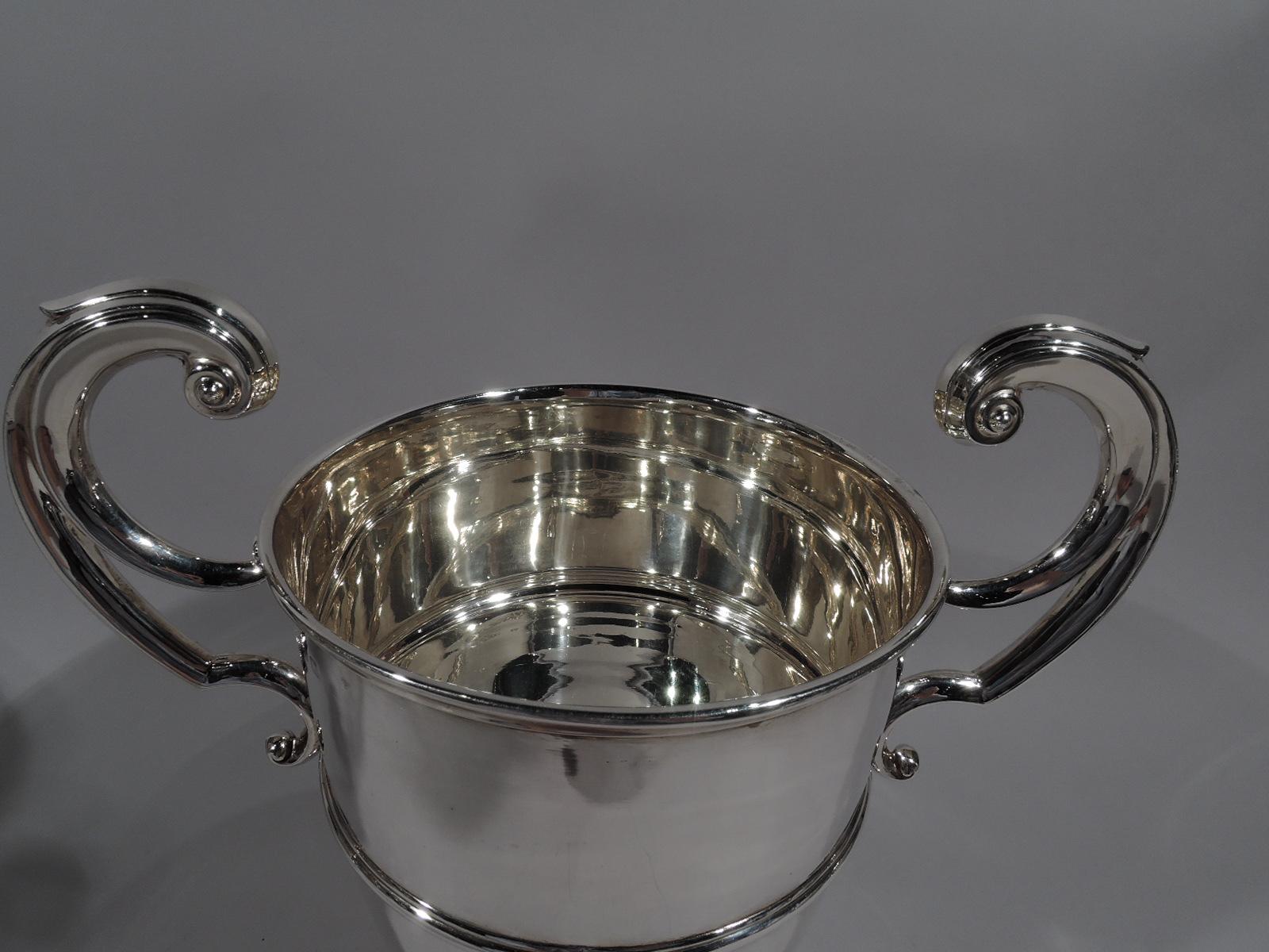 Irish Edwardian Georgian sterling silver trophy cup, 1906. Girdled urn with faceted and capped flying double-scroll side handles and domed foot. Traditional Classicism with lots of room for engraving. Fully marked including Dublin assay stamp and