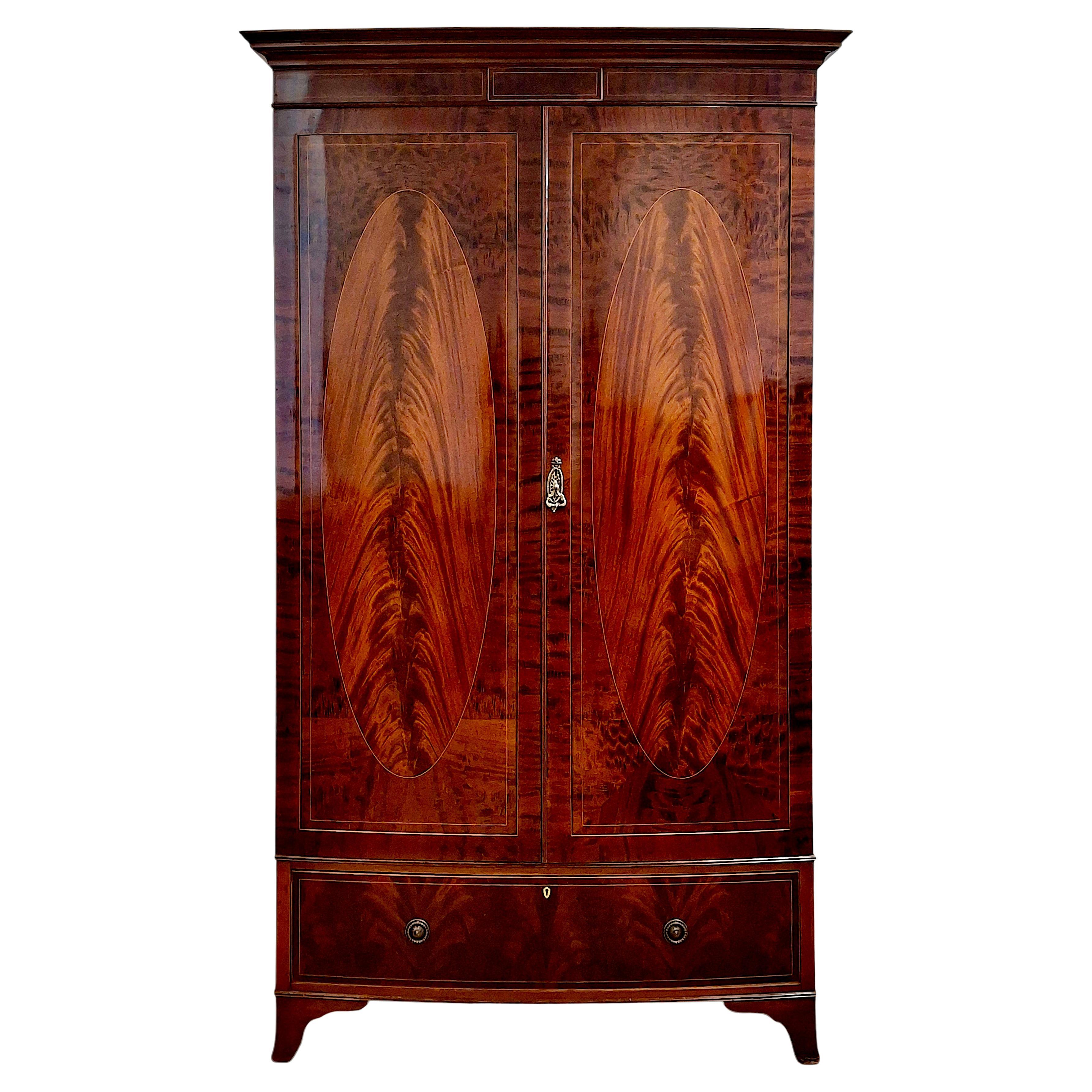 Irish Flame Mahogany bow Front Armoire by Robert Strahan 
Co. For Sale