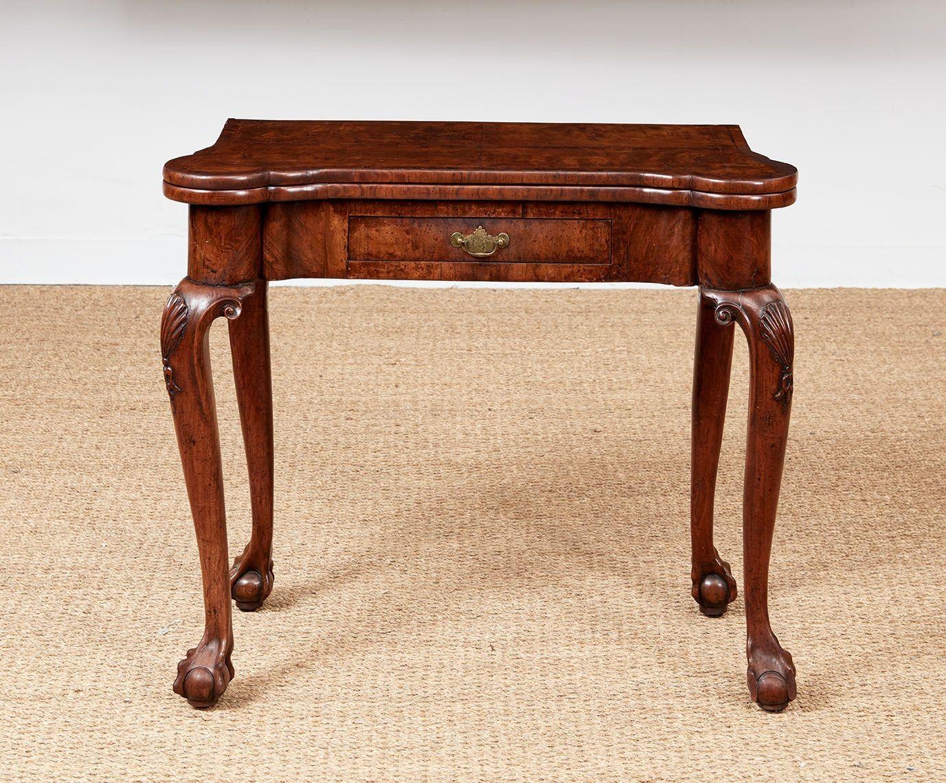 Card or gaming table in beautiful rich walnut timber with shaped serpentine folding top with concertina action accordian sides and single drawer with brass bail pull on elegant shell-carved and scroll carved cabriole legs ending in claw and ball