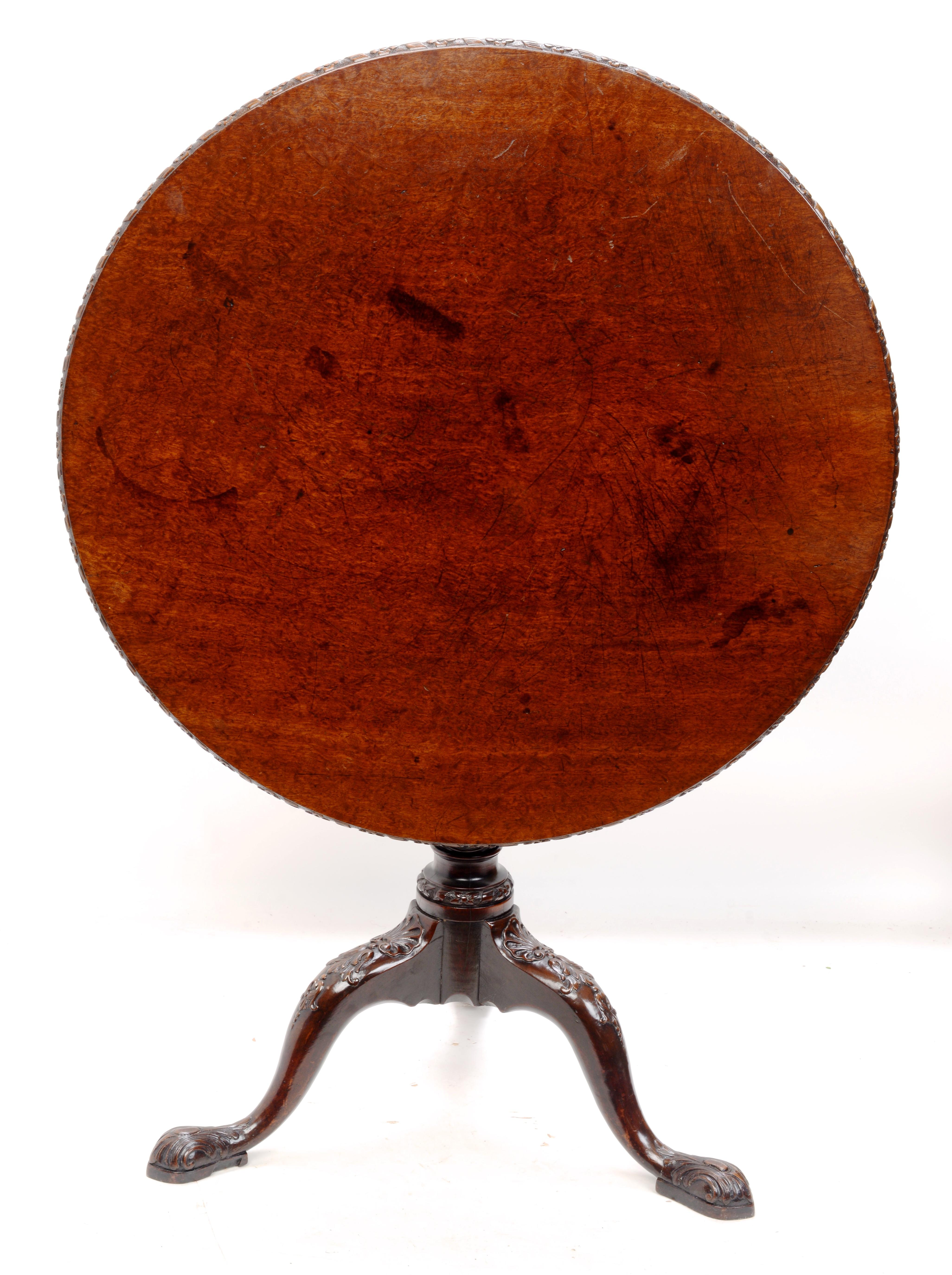 Irish Geo II Plum Pudding Mahogany Tilt and Turn Tripod Tea Table, c1750. Beautifully carved top, legs, pedestal and feet. The table has a great, rich patina. The circular top has floral carved border. The top sits on the original rotating birdcage