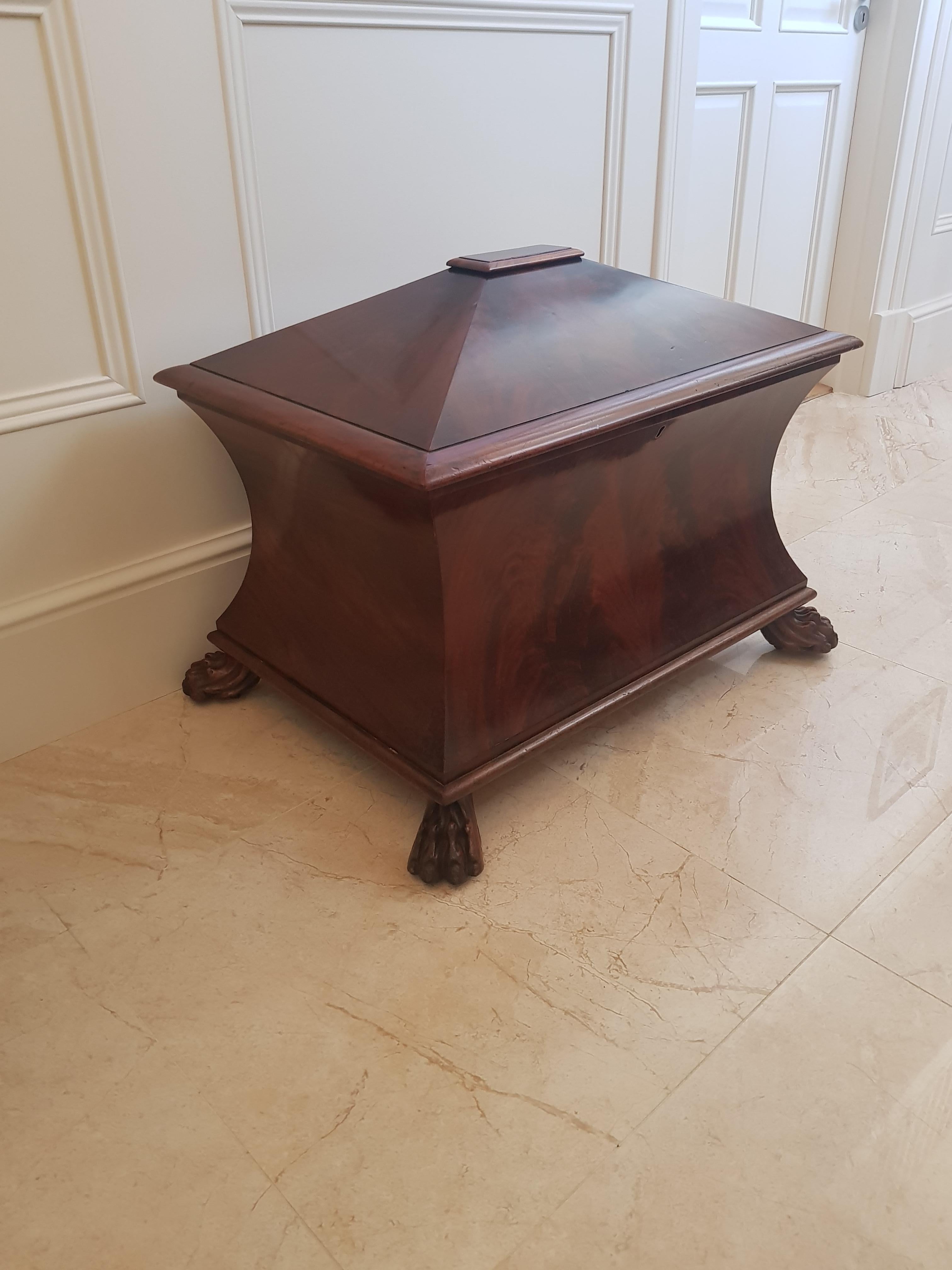 A large and exceptionally rare flared mahogany Irish George IV Cellarette stamped by Mack Williams & Gibton.

Complete with original wooden lining for wine bottle storage and very unusual to find stamped furniture from this illustrious Dublin
