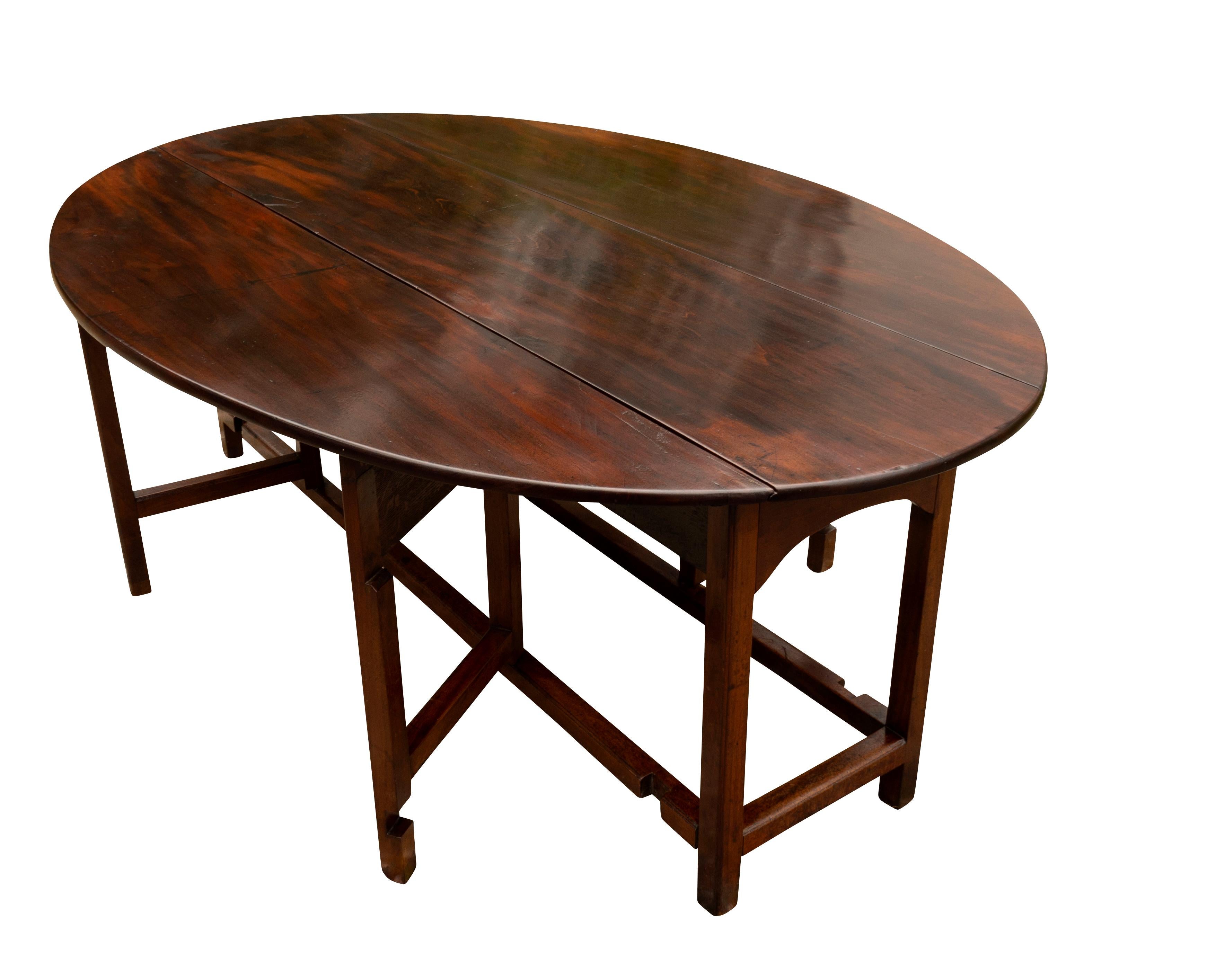 With heavy dense mahogany top and D shaped hinged leaves with square section legs with two swing out legs per side , box stretcher. A good period table with added height for todays seating. The mahogany with very dark color. My restorer said that