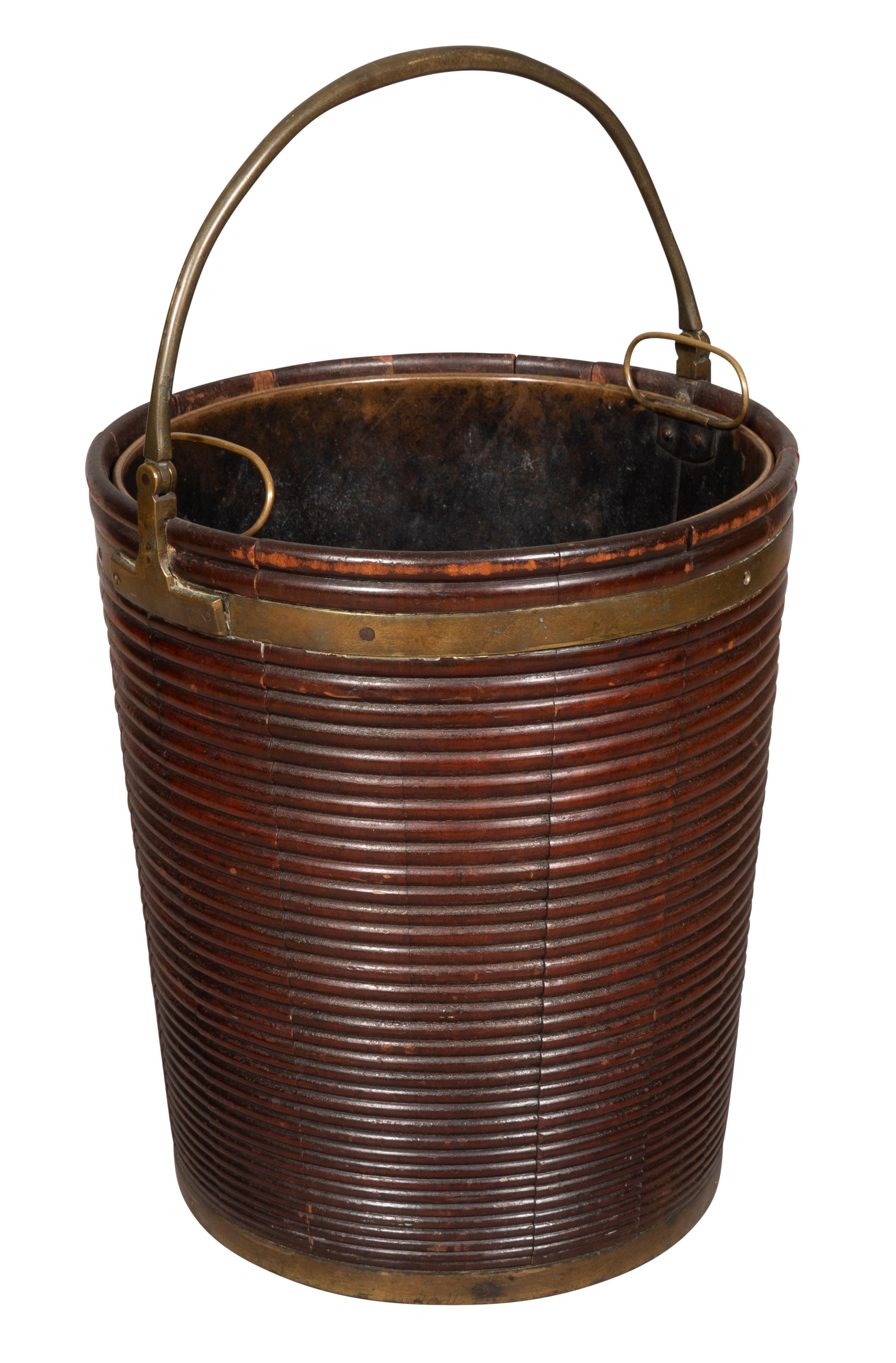 Circular ribbed tapered body with brass liner and brass bail handle.