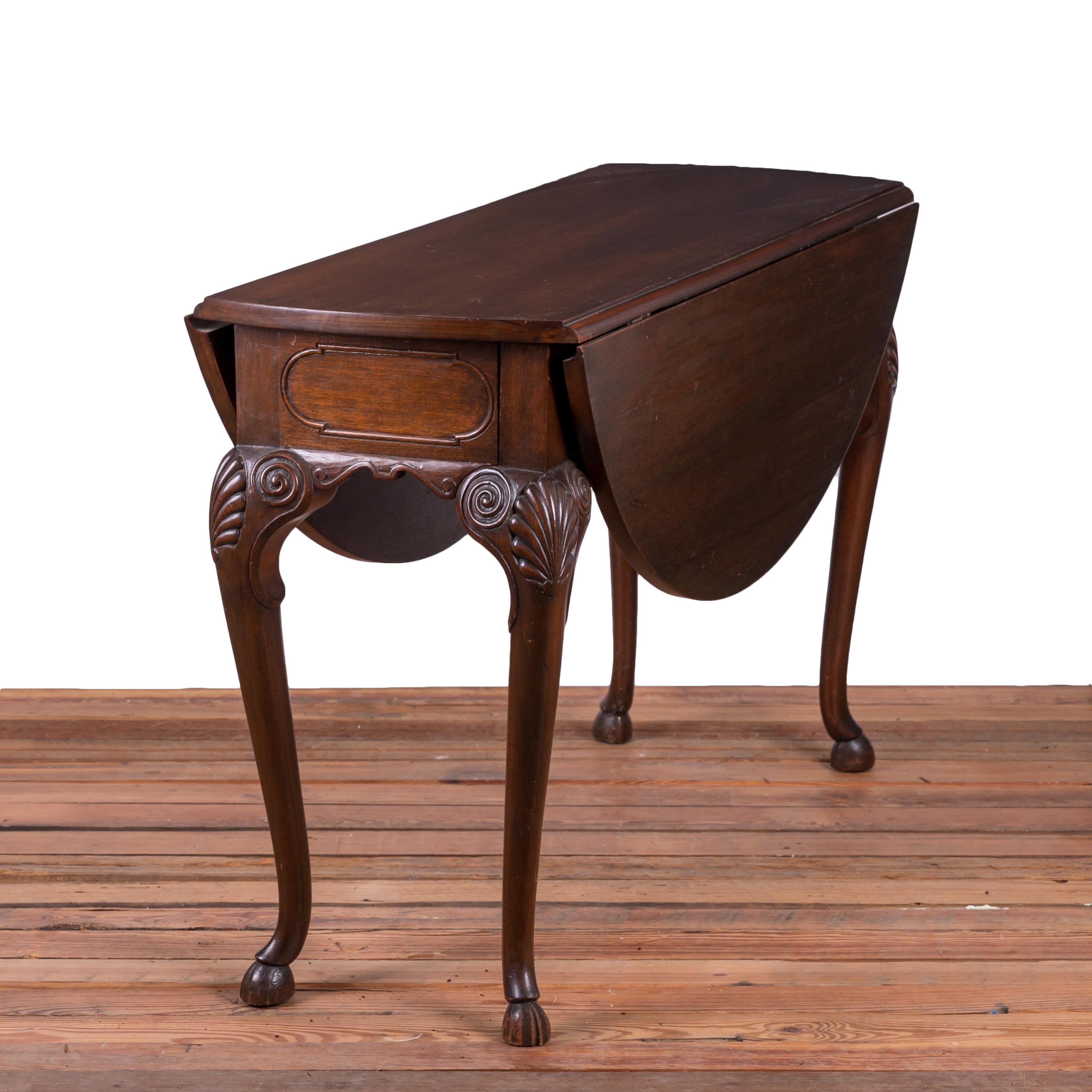 A Irish Georgian style red walnut drop leaf table, late 19th century.

Round top with one gate leg and one bracket support.  A cartouche carved frieze over shell carved cabriole legs with hoof feet.

44 inches wide by 17 ¼ inches deep by 29 ¼ inches