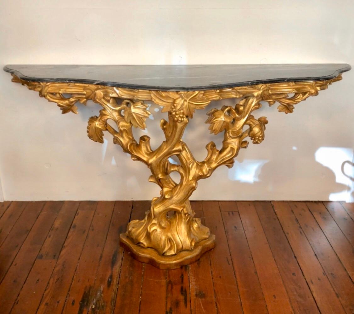 This 18th century whimsical giltwood console is designed in the French 'picturesque' style. The console is hand carved with fine detail given to the grapevine and grapes.