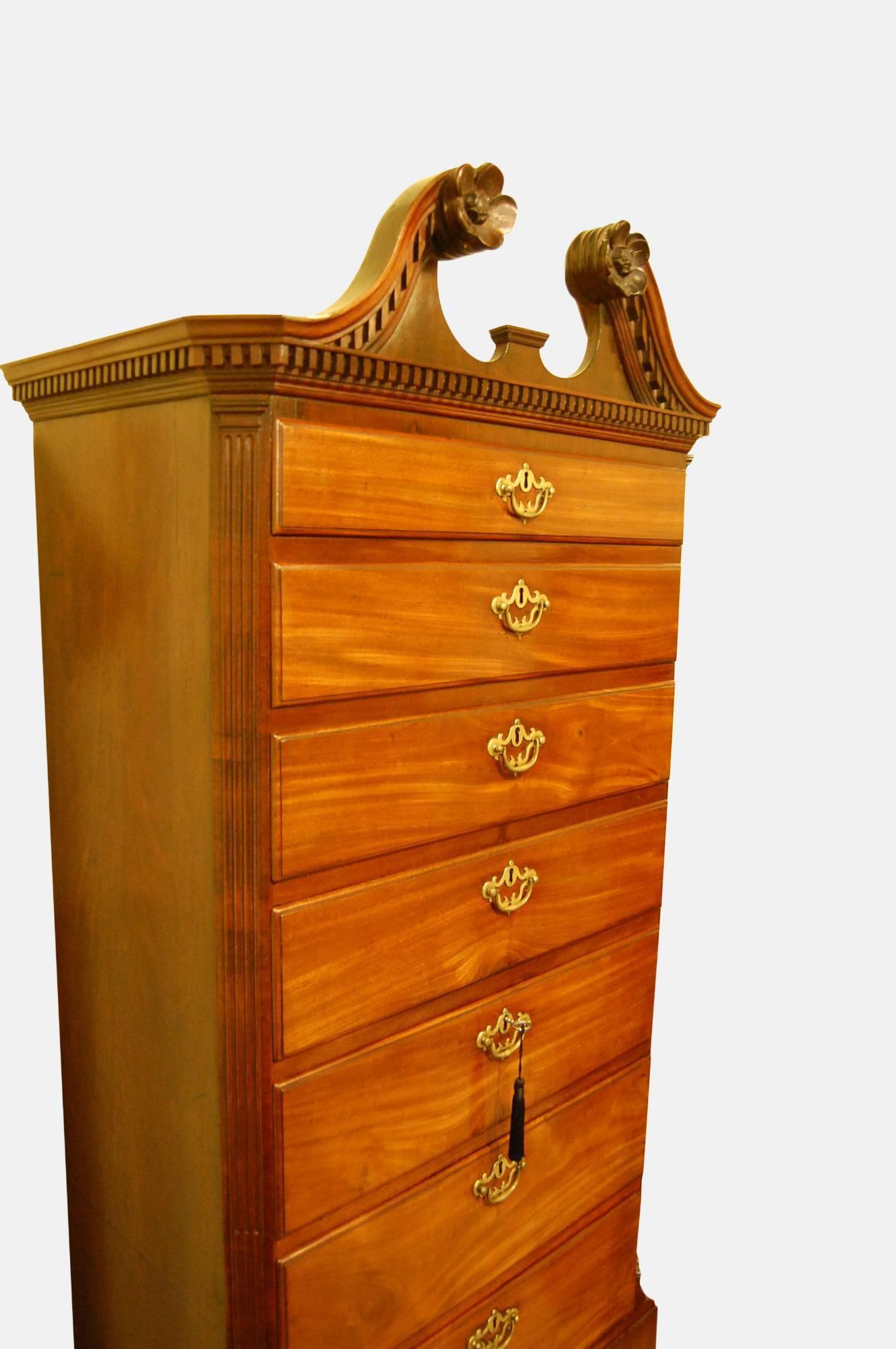 A fine mid-18th century carved mahogany Irish highboy of rare form

Seven graduated drawers flanked by stop fluted canted corners

Dentil moulded swan neck pediment with rosette carved terminals

Raised on conforming but not original
