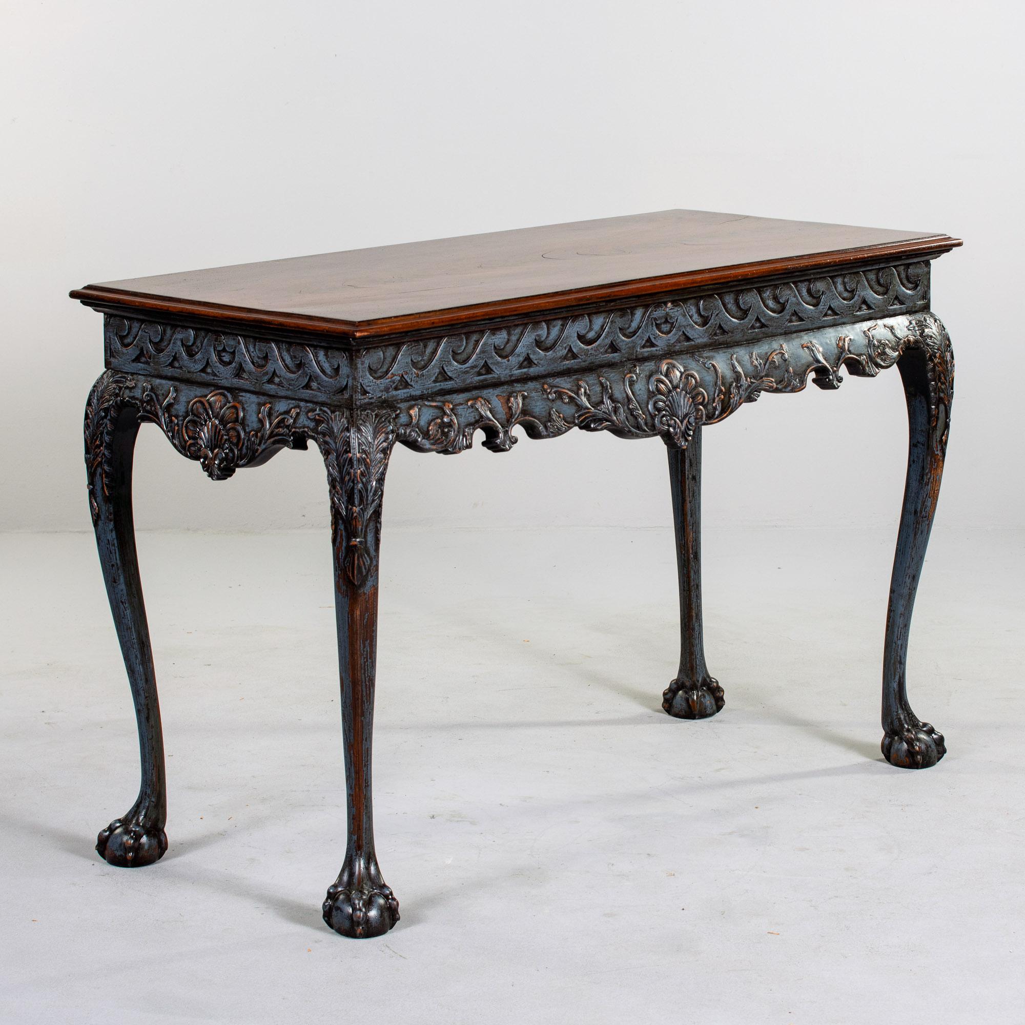 Found in England, this mahogany console dates from approximately 1910. Ornately carved base and claw and ball feet have blue painted finish. Beautifully figured mahogany on table top. Unknown maker. Very good overall antique condition with some