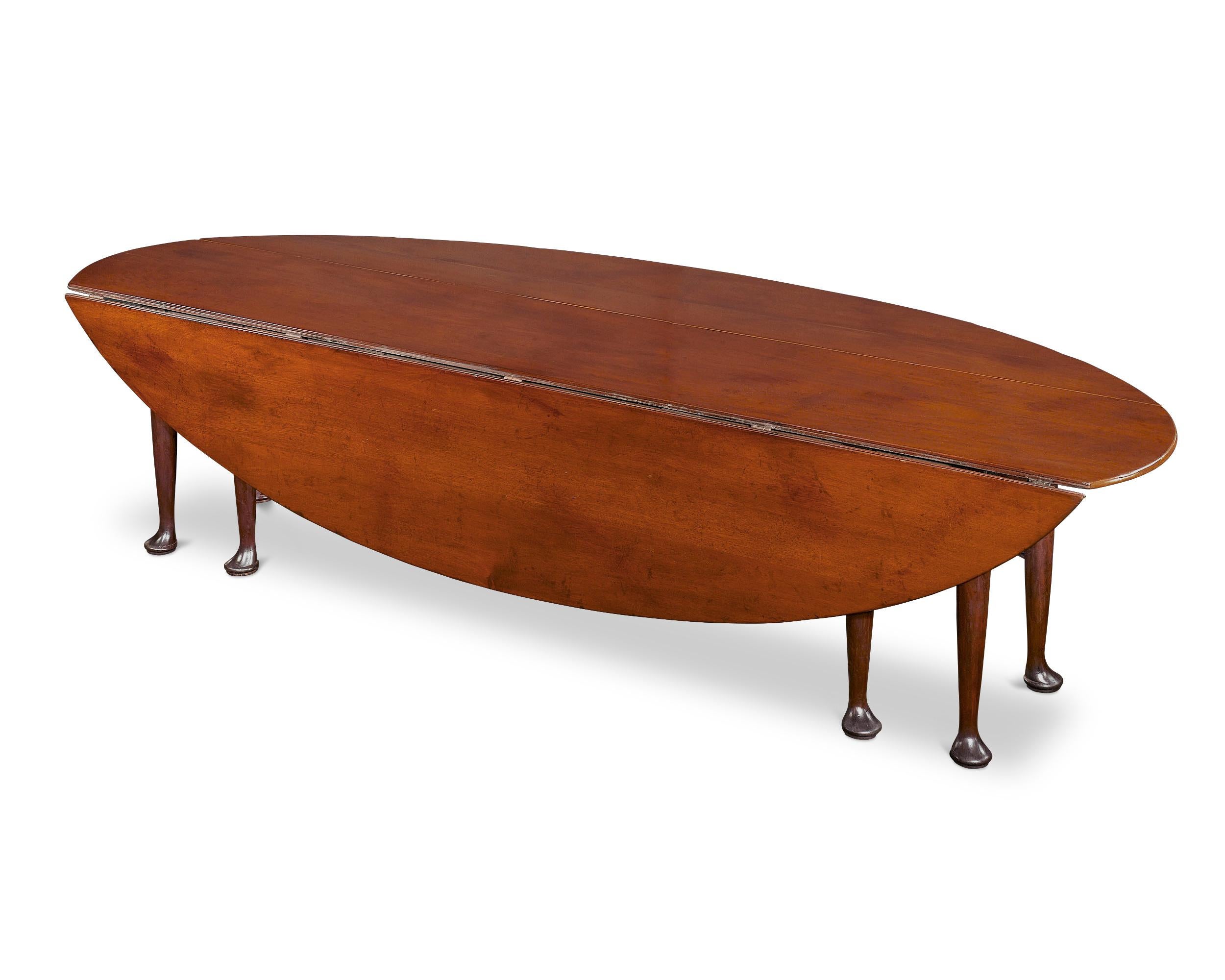 Both outstanding design and rich tradition set apart this intriguing Irish mahogany table. Often referred to as a “wake” table, this extra-long oval table would have once been used year-round as a dining table. Yet, it also served as the focal