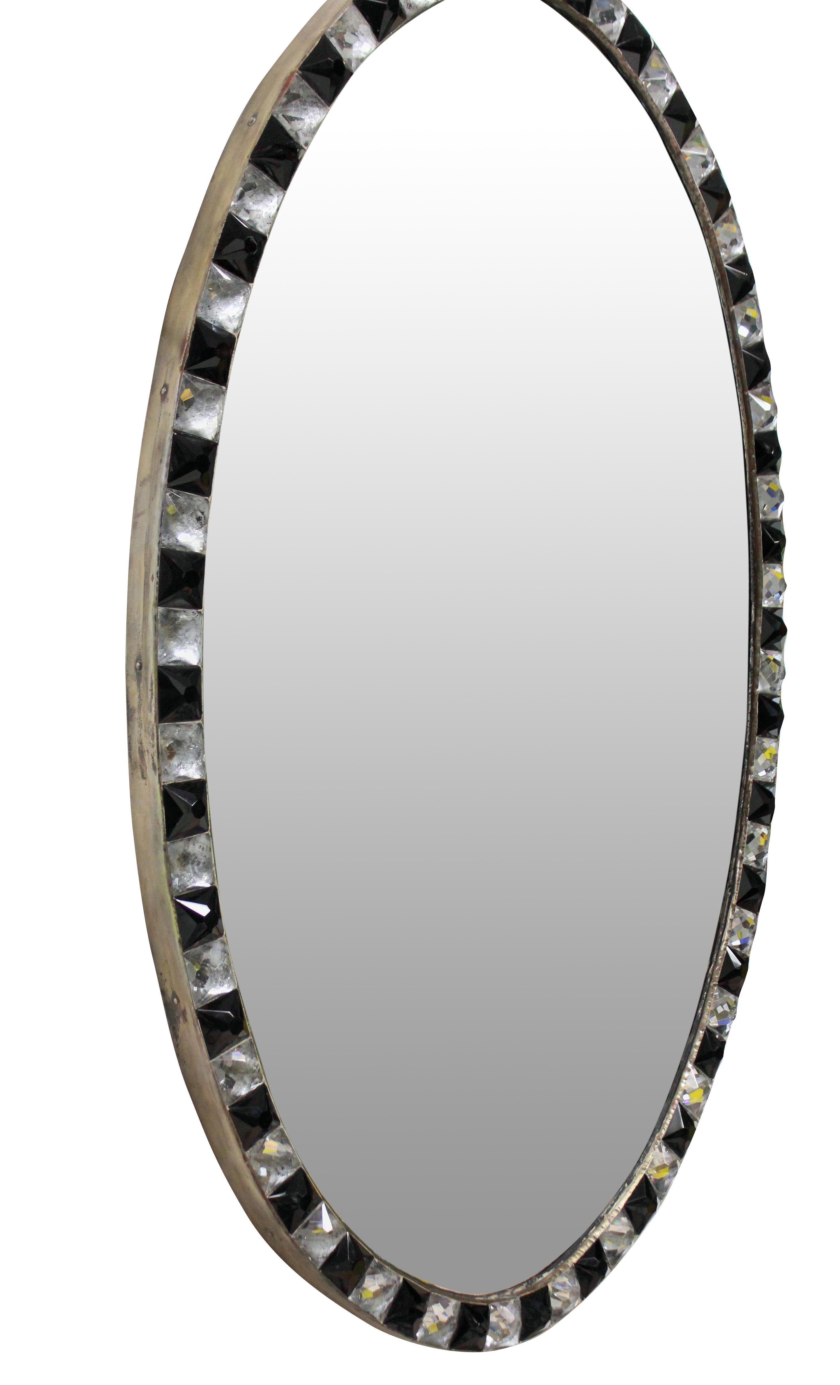 An Irish mirror in the George III style, of good quality with a faux mercury glass mirror plate pinned into a patinated copper frame, bordered with rock crystal and black glass faceted studs in the traditional 18th century manner. Of good weight and