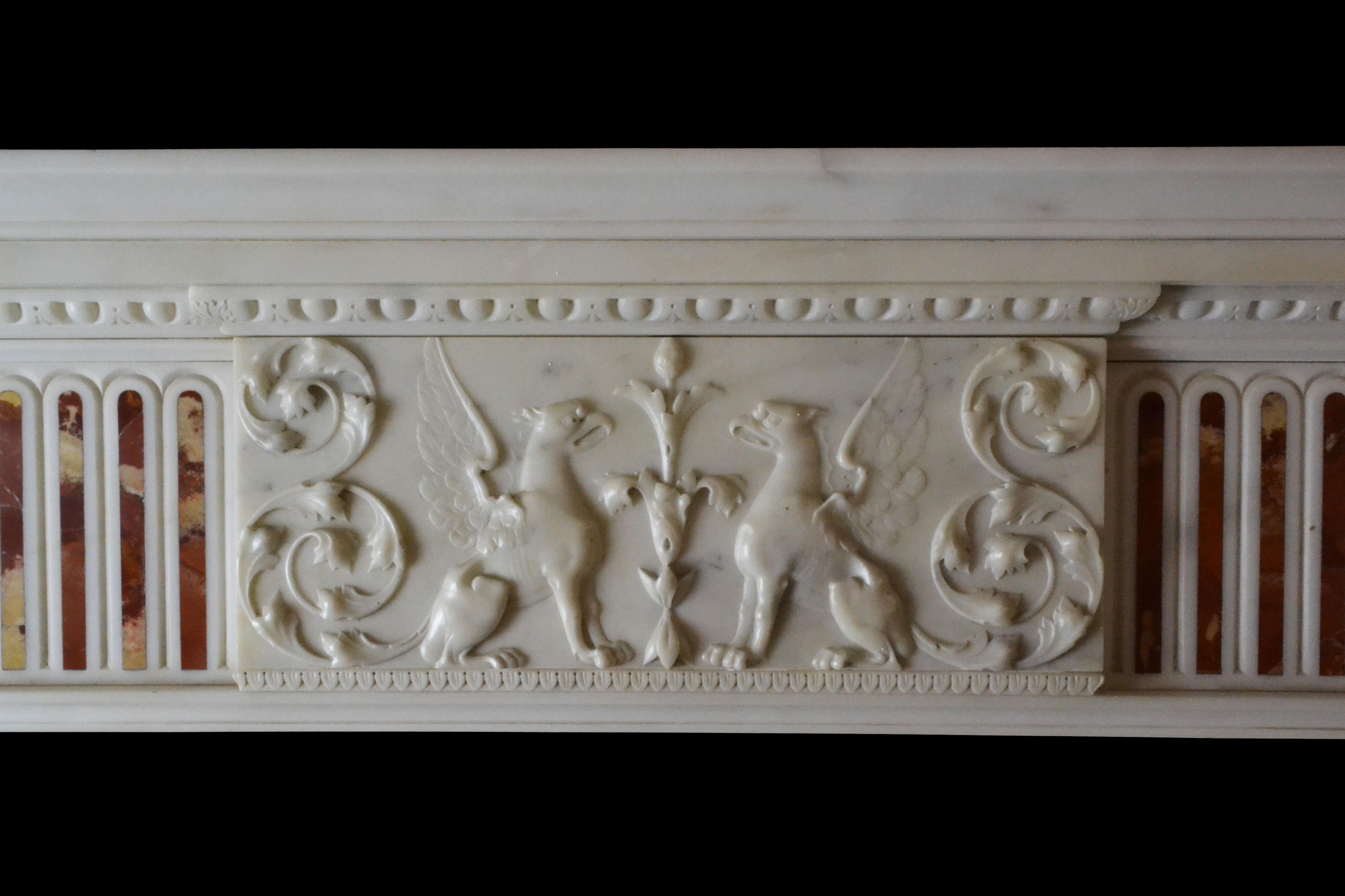 A very fine late 18th century Irish neo-classical chimneypiece of elegant proportions in Statuary marble with tapering pilasters inlaid with blind flutes of Convent Siena marble which terminate beneath corner blocks carved with fruit filled