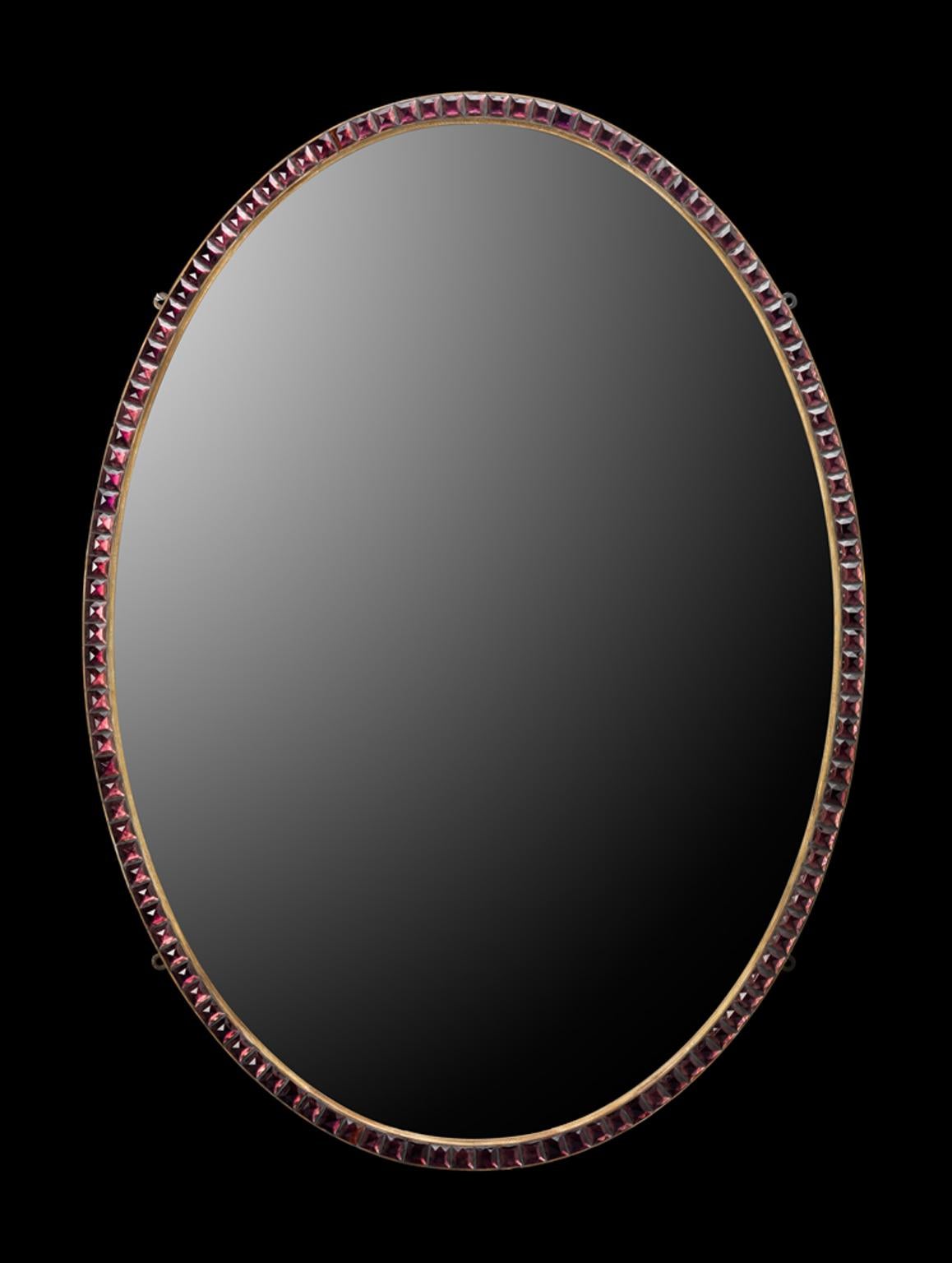 A fine Irish oval mirror with narrow moulded and gilt frame, inset with Irish glass tapered facets.