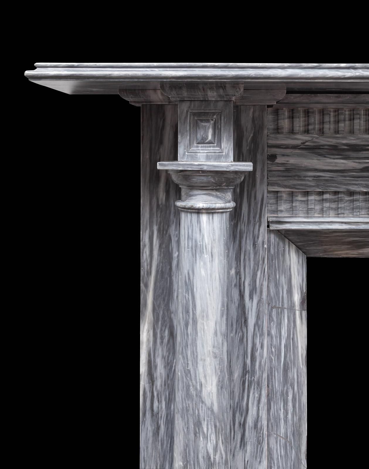 An Irish antique Regency grey Bardiglio marble fireplace. 
The moulded shelf sits above projecting end-blocks carved with recessed panels, these are supported by full rounded Tuscan columns standing freely in front of plain pilasters. The frieze