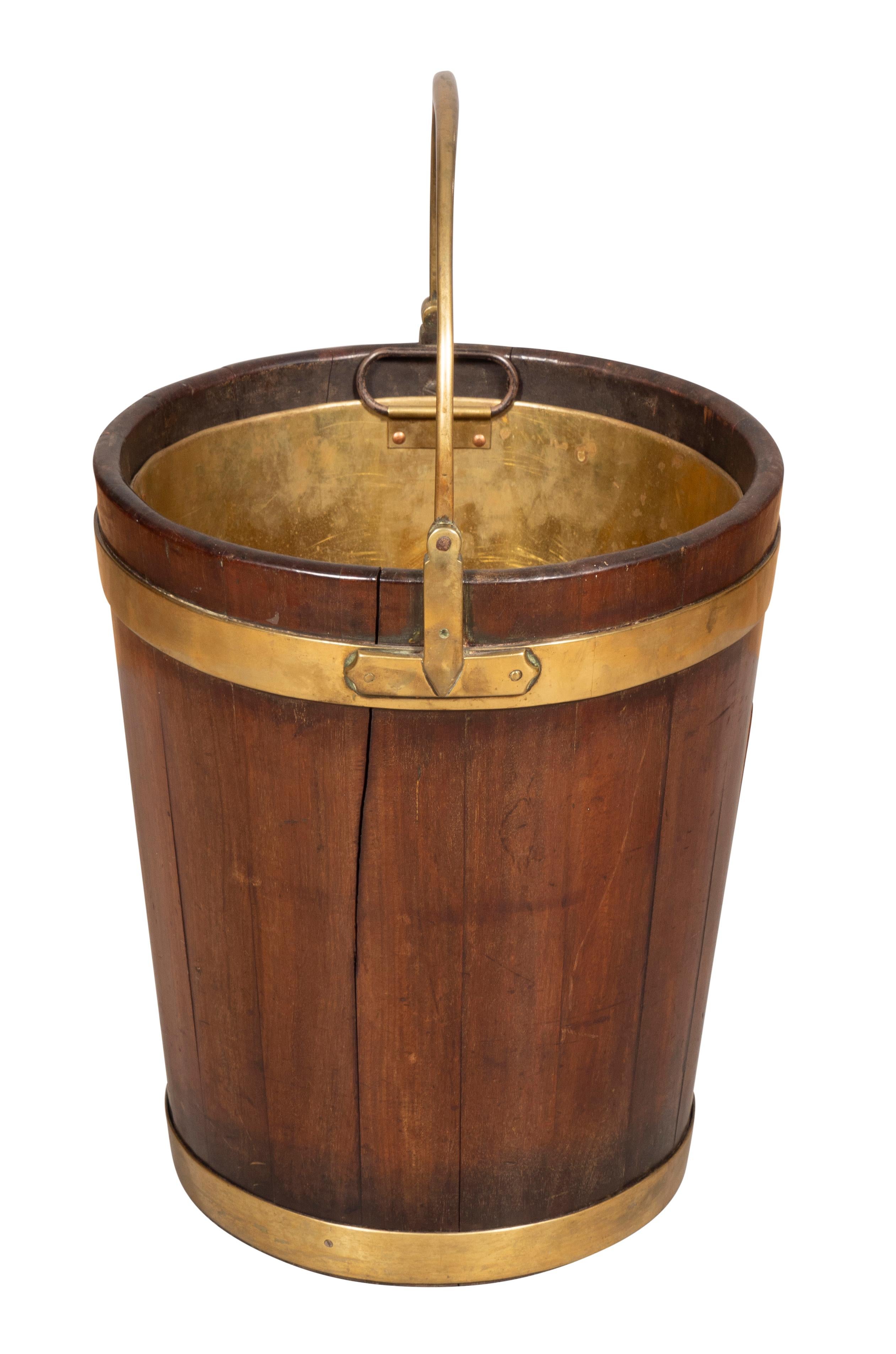 Handle up 24 high. With brass handle and cylindrical bucket with brass strapping. Removable brass liner.