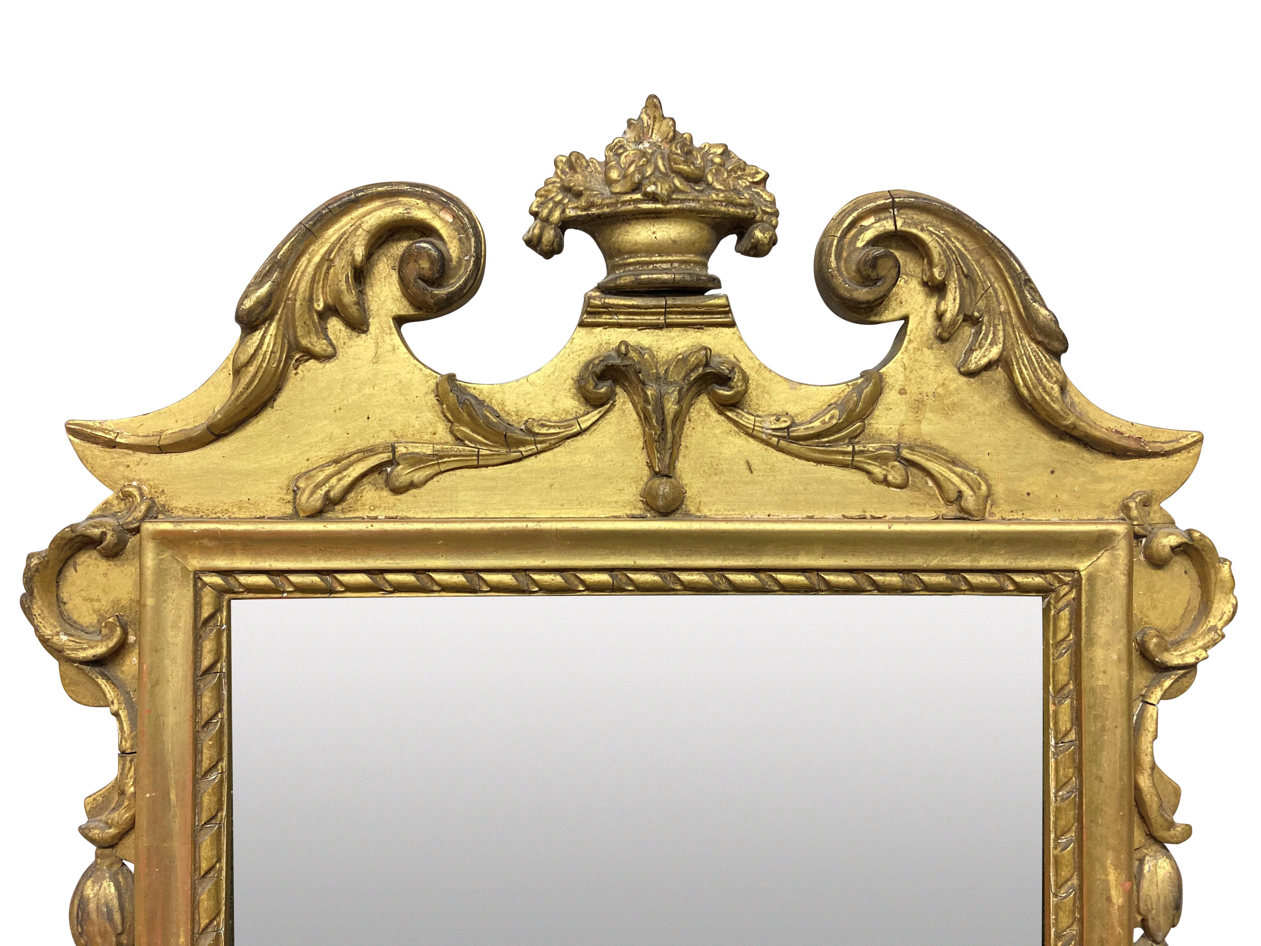 An Irish Regency period water gilded mirror, with a pedimented top, swags and acathus decoration.
