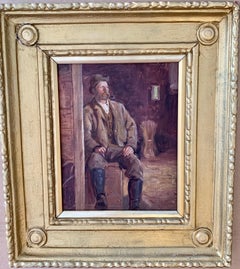 Antique 19th century Irish portrait of a man, smoking a Pipe, seated in a barn interior.