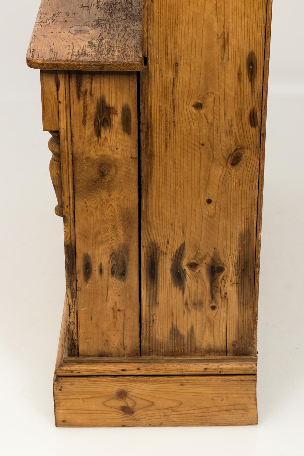Irish scrub pine cupboard with open plate rack, two drawers, and a bottom cupboard, circa late 19th century.
     