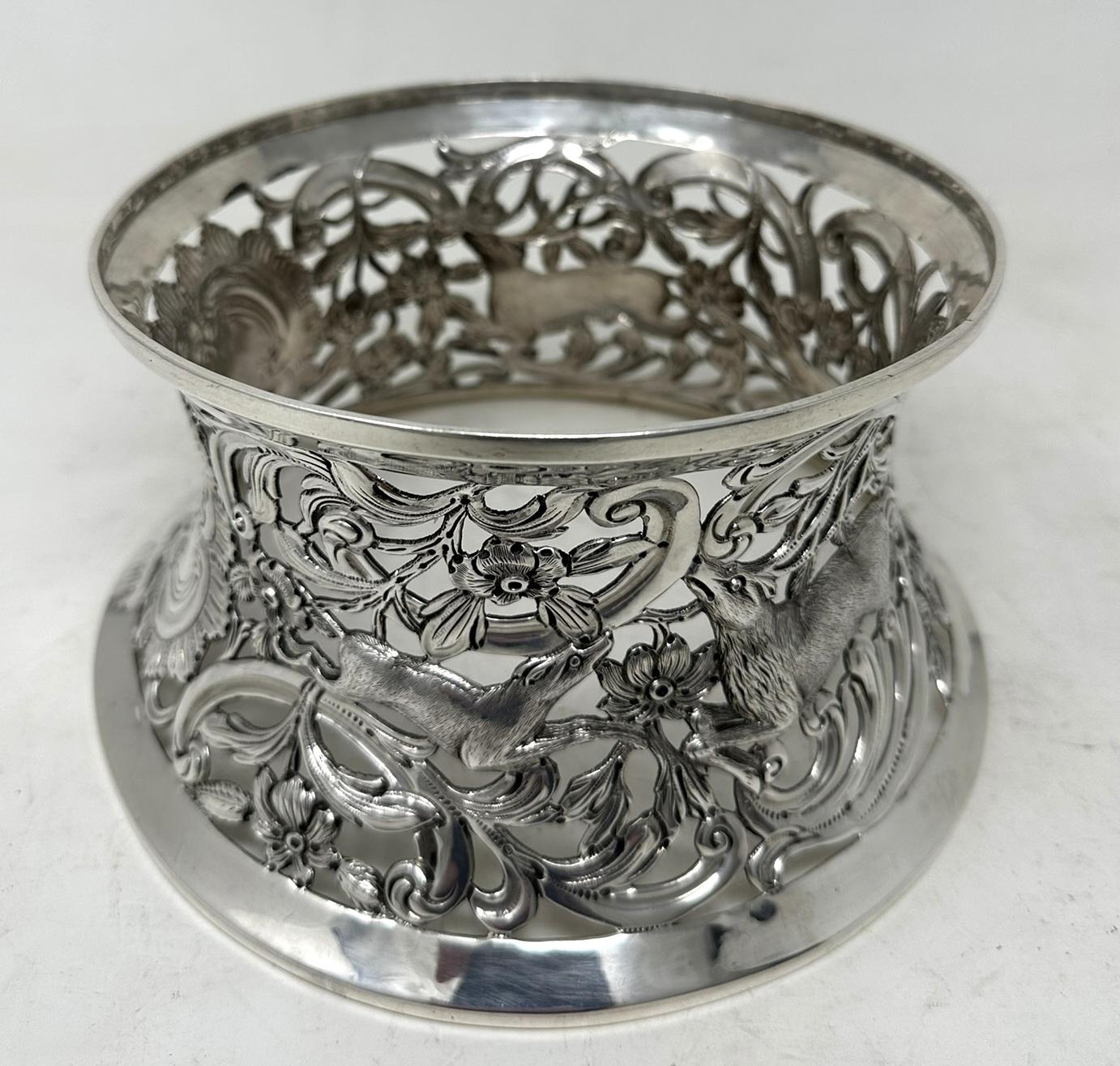 An Exquisite Irish Georgian Style Edwardian Dublin Silver Heavy Gauge Table Dish Ring of traditional waisted form in the Rococo manner, and unusually large size. 

The circular inverted sided lavish pierced body depicting a rustic scene with