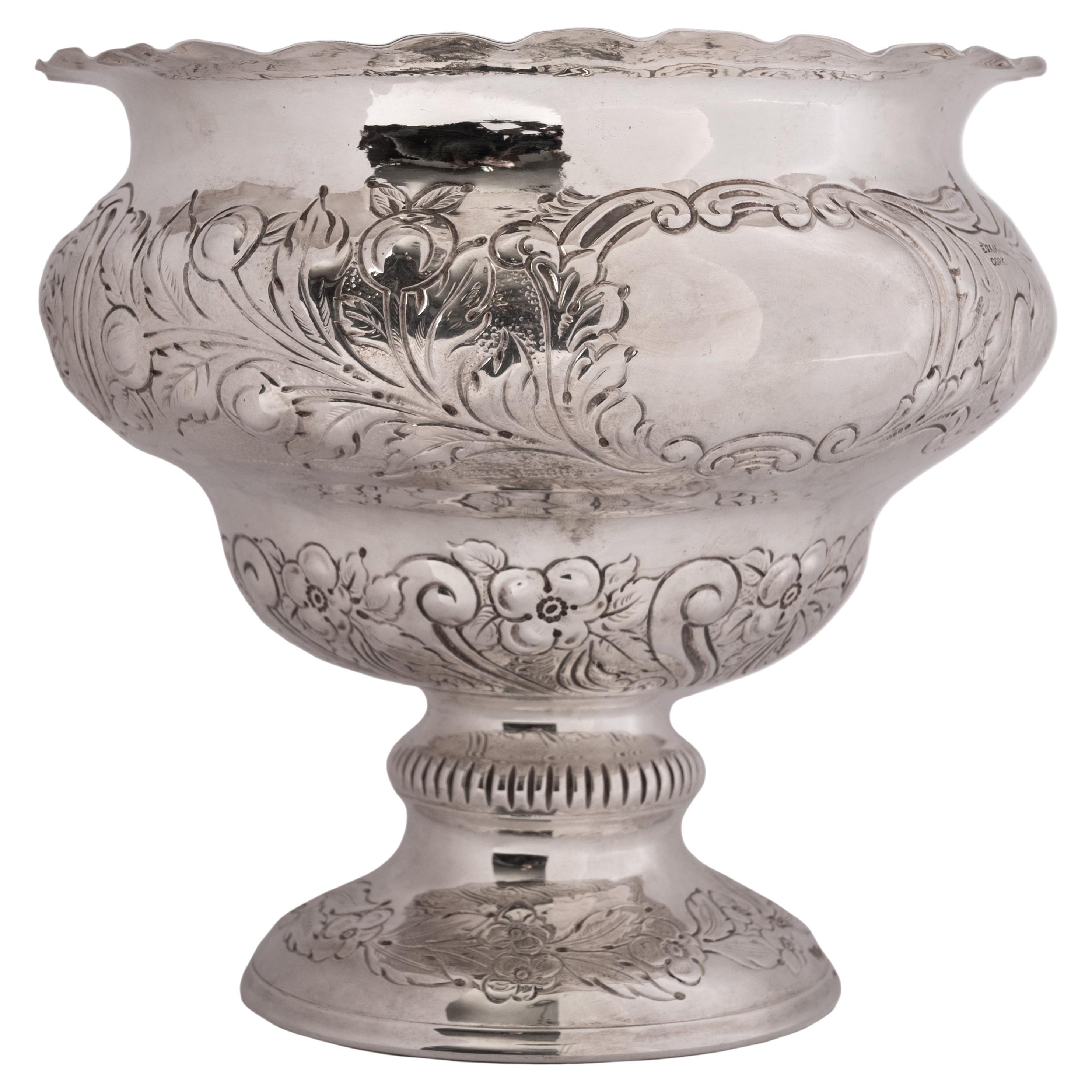 A fine antique Irish sterling silver footed bowl by William Egan, County Cork, 1911.
The bowl having an everted rim above a stepped globular body which is decorated with repousse work and also finely engraved, the bowl having a blank cartouche (no