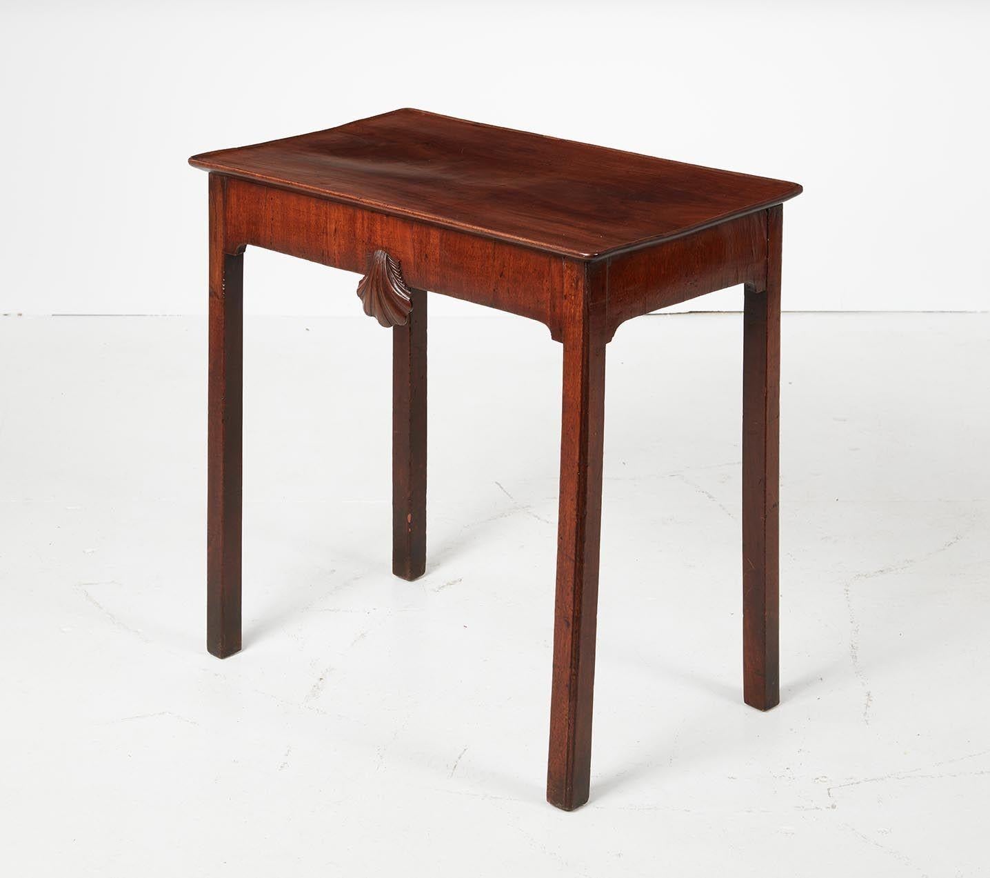 Good mid 18th Century Irish mahogany side table, the heavily dish molded single plank top over apron with bold shell carving, standing on square legs with inner chamfer, the whole with good rich color and patination and nicely figured timber.