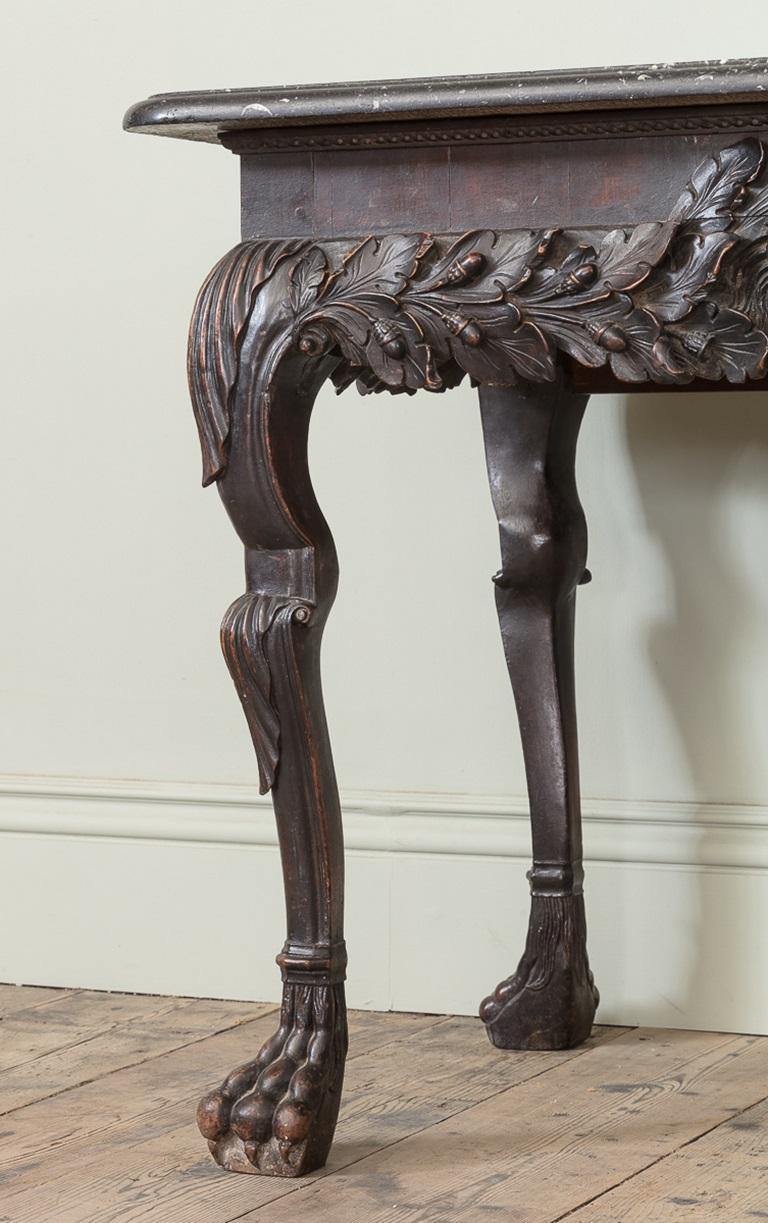 A Magnificent 18th Century Irish Walnut Console Table, with Irish Kilkenny Marble Top

With bold and handsomely carved oak leaves and acorn across the apron, and enormously characterful central half lion mask, with carved leaf and shaped cabriole