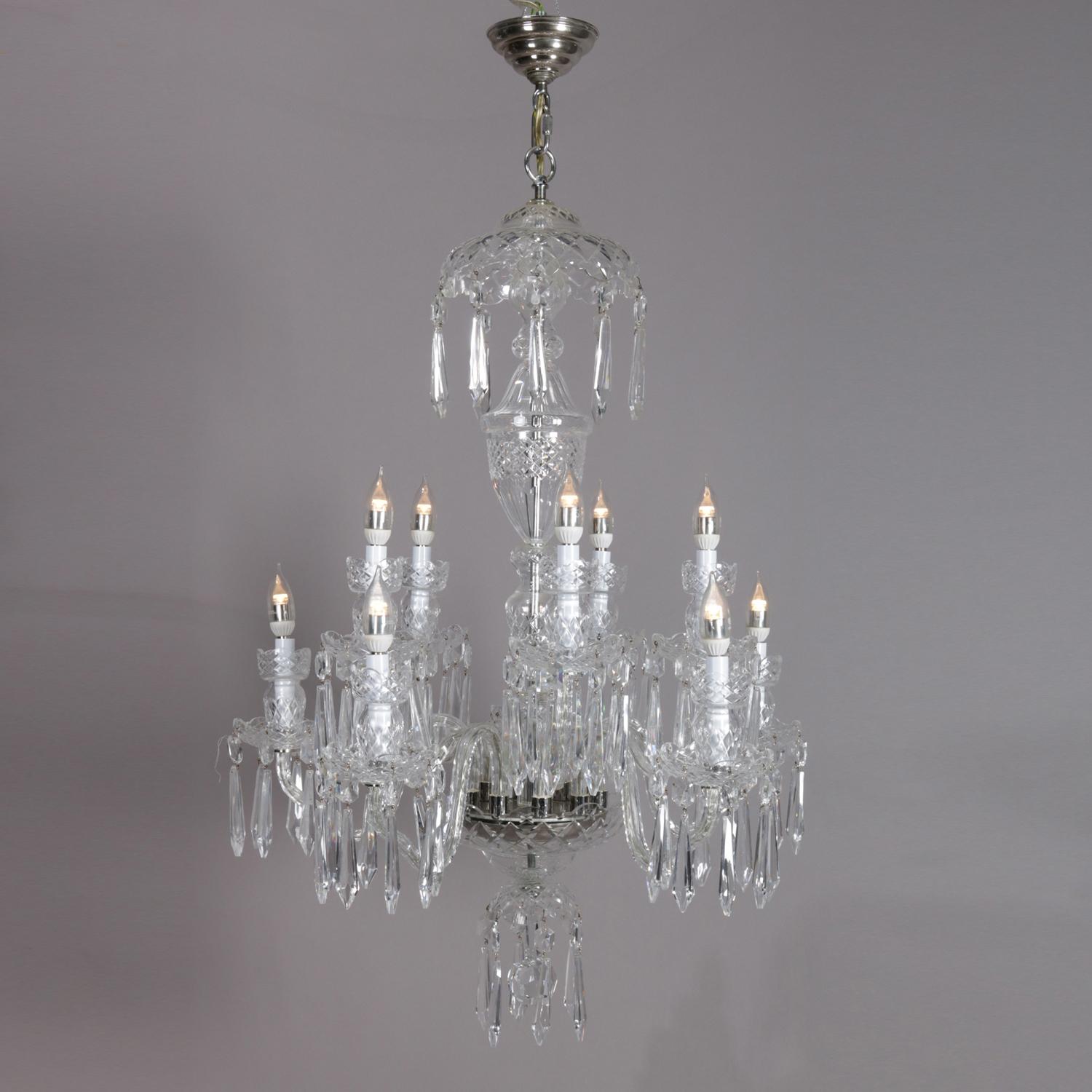 Irish Waterford chandelier features chrome frame with diamond patterned cut crystal urn form body with ten S-scroll crystal arms terminating in candle lights, highlighted with hanging cut crystals, signed Waterford including prisms, circa