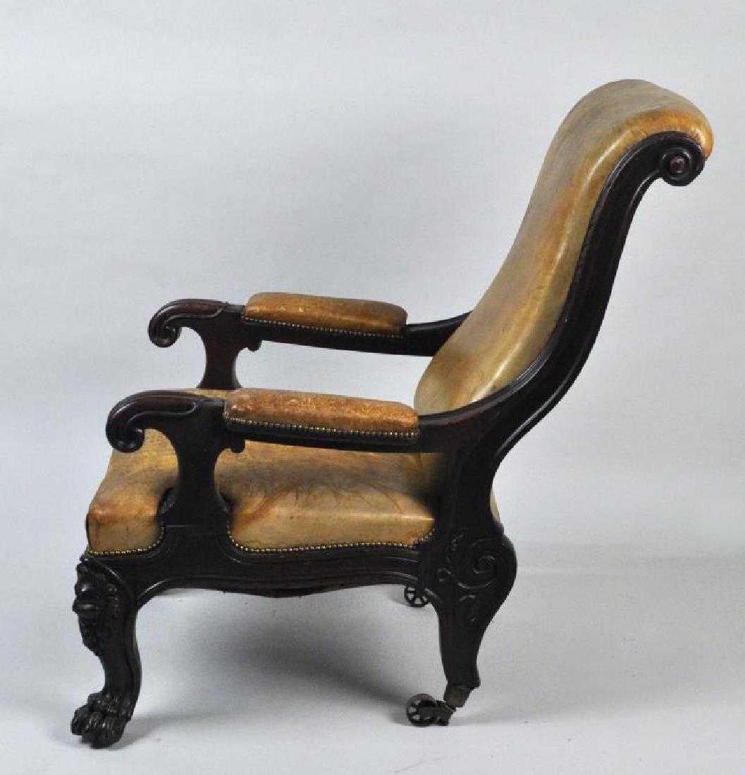 Bold Irish 19th century mahogany library chair with olive tufted leather upholstery having richly carved scroll arms and back, the legs with lion masks and paw feet, retaining an old rich finish, Probably Dublin, circa 1835.

Measures: 43