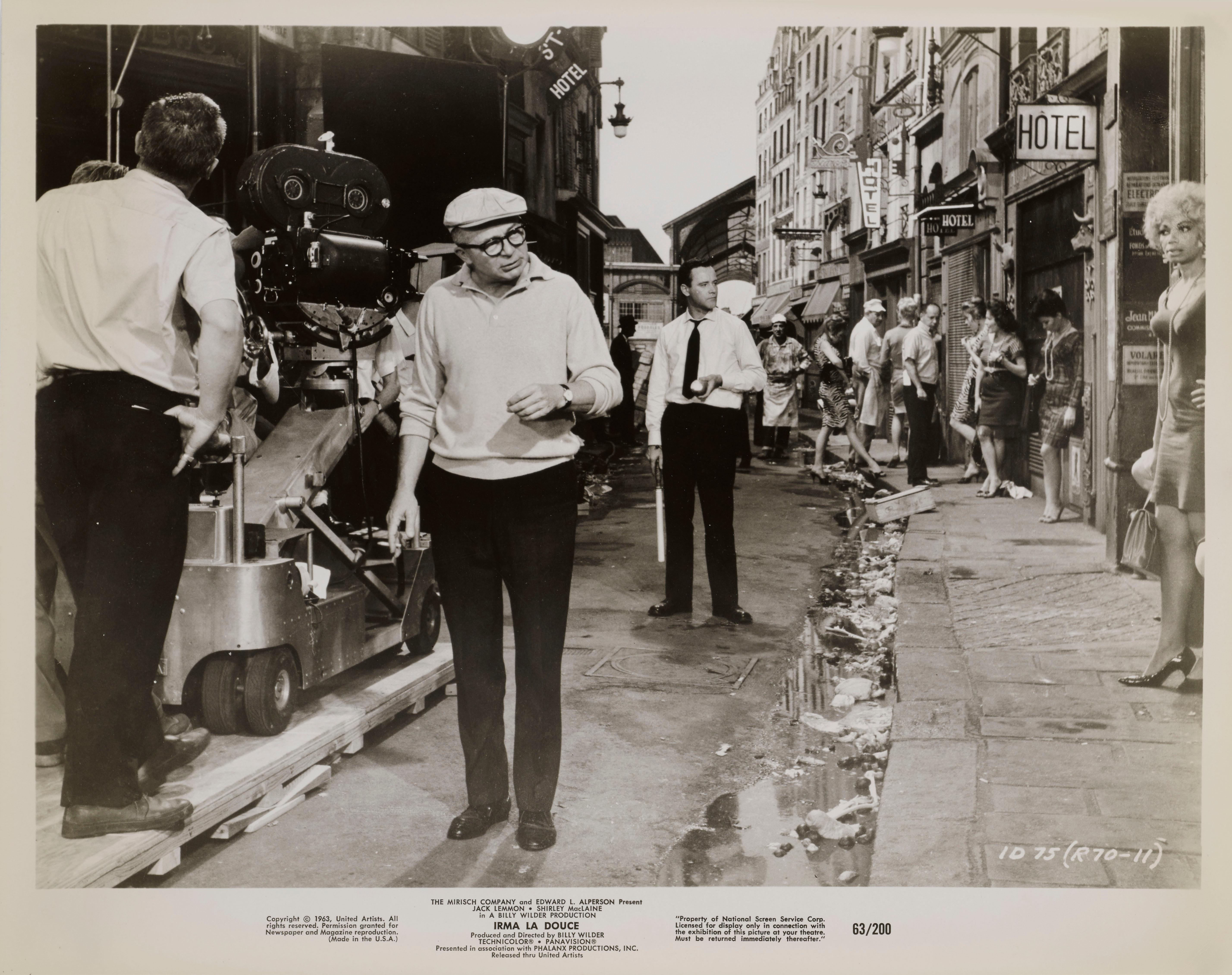Original US photographic production still from the film Irma La Douce, 1963. Starring Shirley MacLaine, Jack Lemmon and directed by Billy Wilder. This production still shows Billy Wilder on set with Jack Lemmon. The piece would be shipped flat in