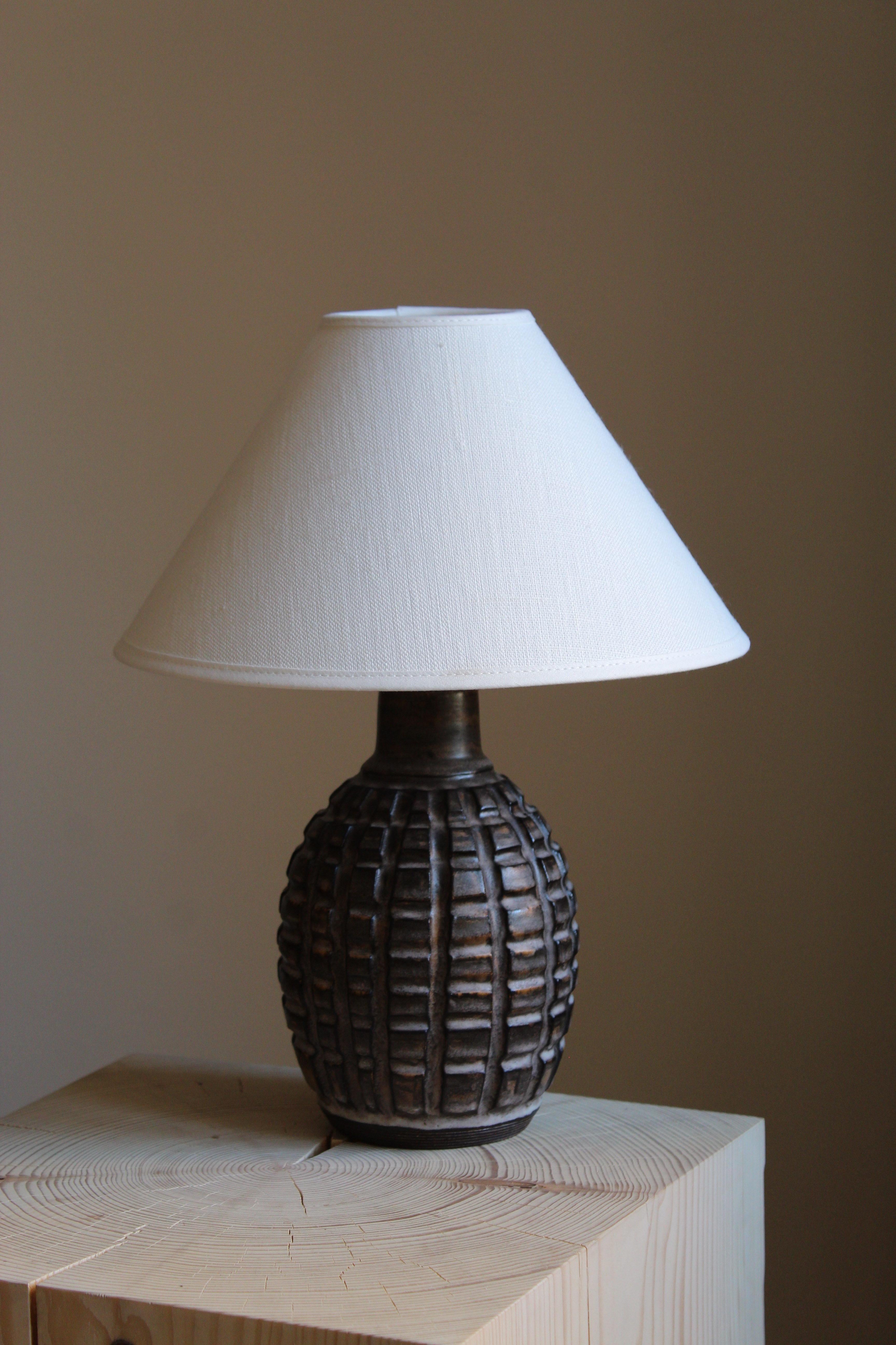A table lamp by ceramic artist and designer Irma Youstone. Designed and produced in artists' own studio. Sweden, c. 1960s. Sold without lampshade.