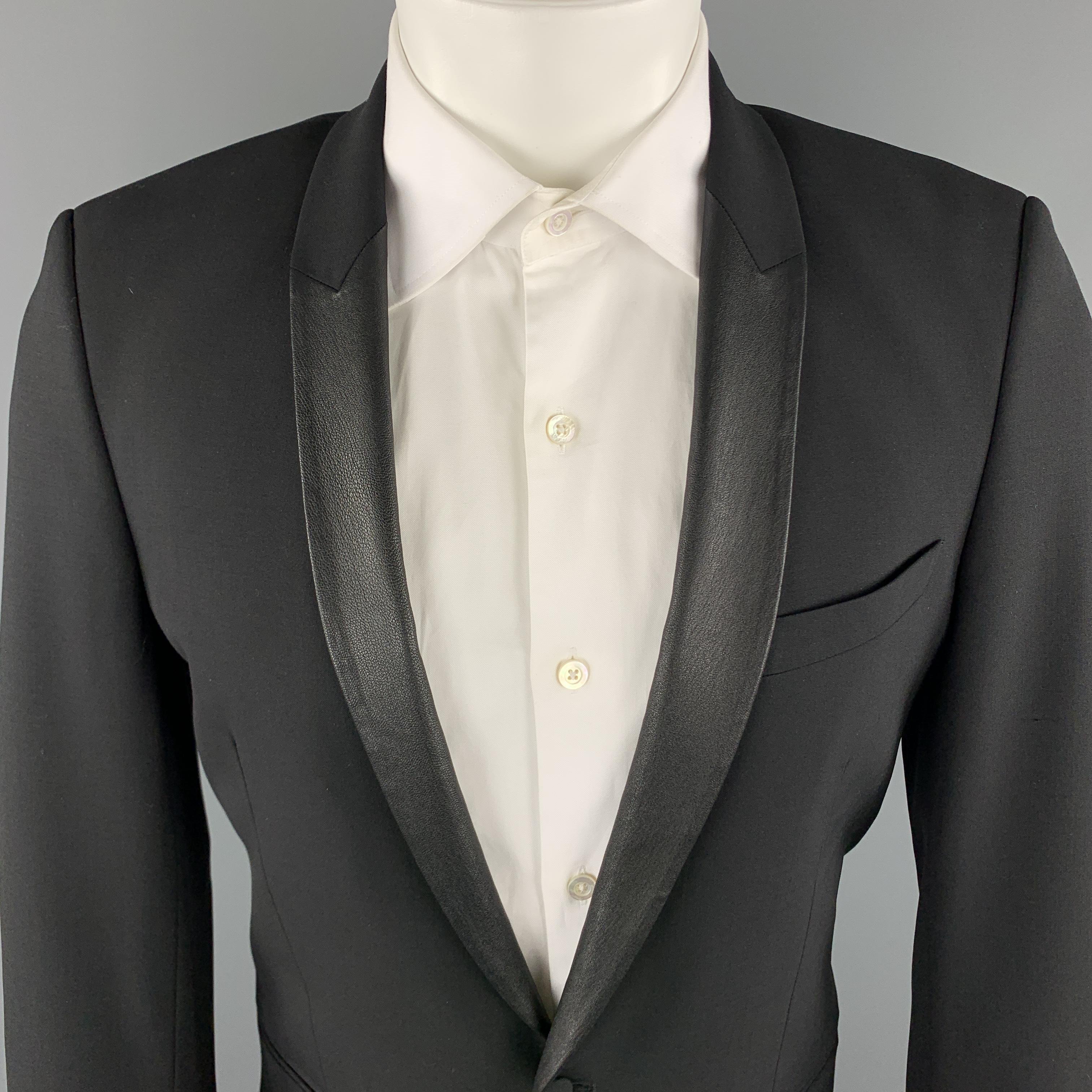 IRO sport coat comes in a black wool blend material, featuring a shawl collar, a leather trim, a single button at closure, slit pockets, single breasted, functional buttons at cuffs, and a single vent at back. Made in Romania.

Excellent Pre-Owned