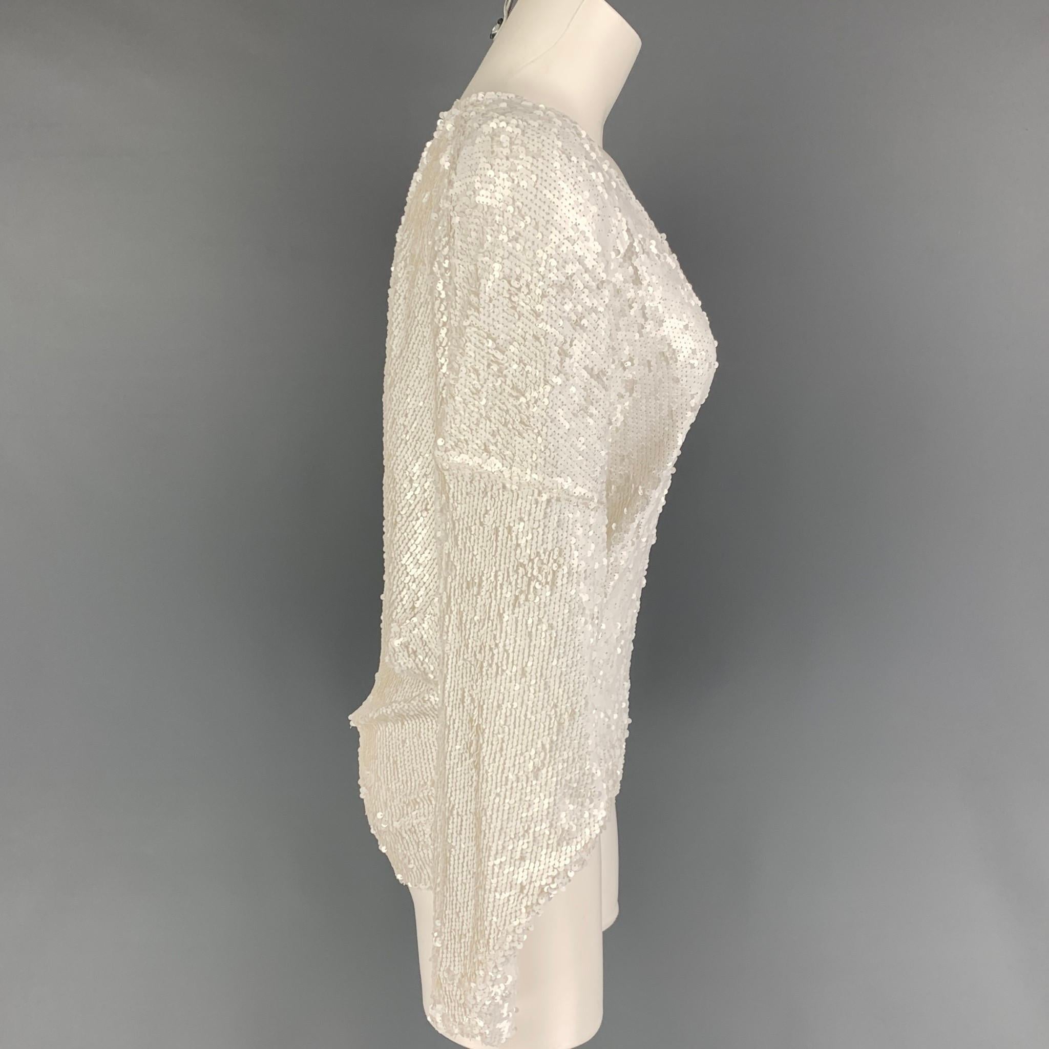 IRO dress top comes in a white sequin nylon featuring batwing sleeves and a v-neck. 

Very Good Pre-Owned Condition.
Marked: 34

Measurements:

Shoulder: 27 in.
Bust: 44 in.
Sleeve: 18.5 in.
Length: 25 in. 