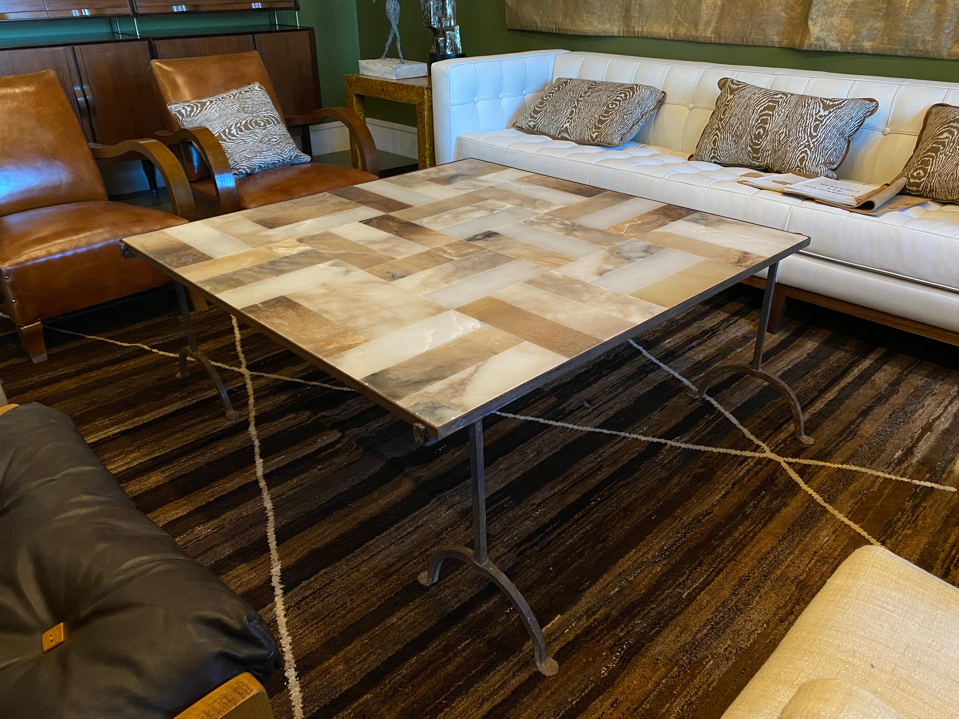 Square cocktail table with removable iron legs and iron framed alabaster top. Distinctive alabaster stone pieces in parquet style pattern, France, 1930s
Measures: Base: W 58