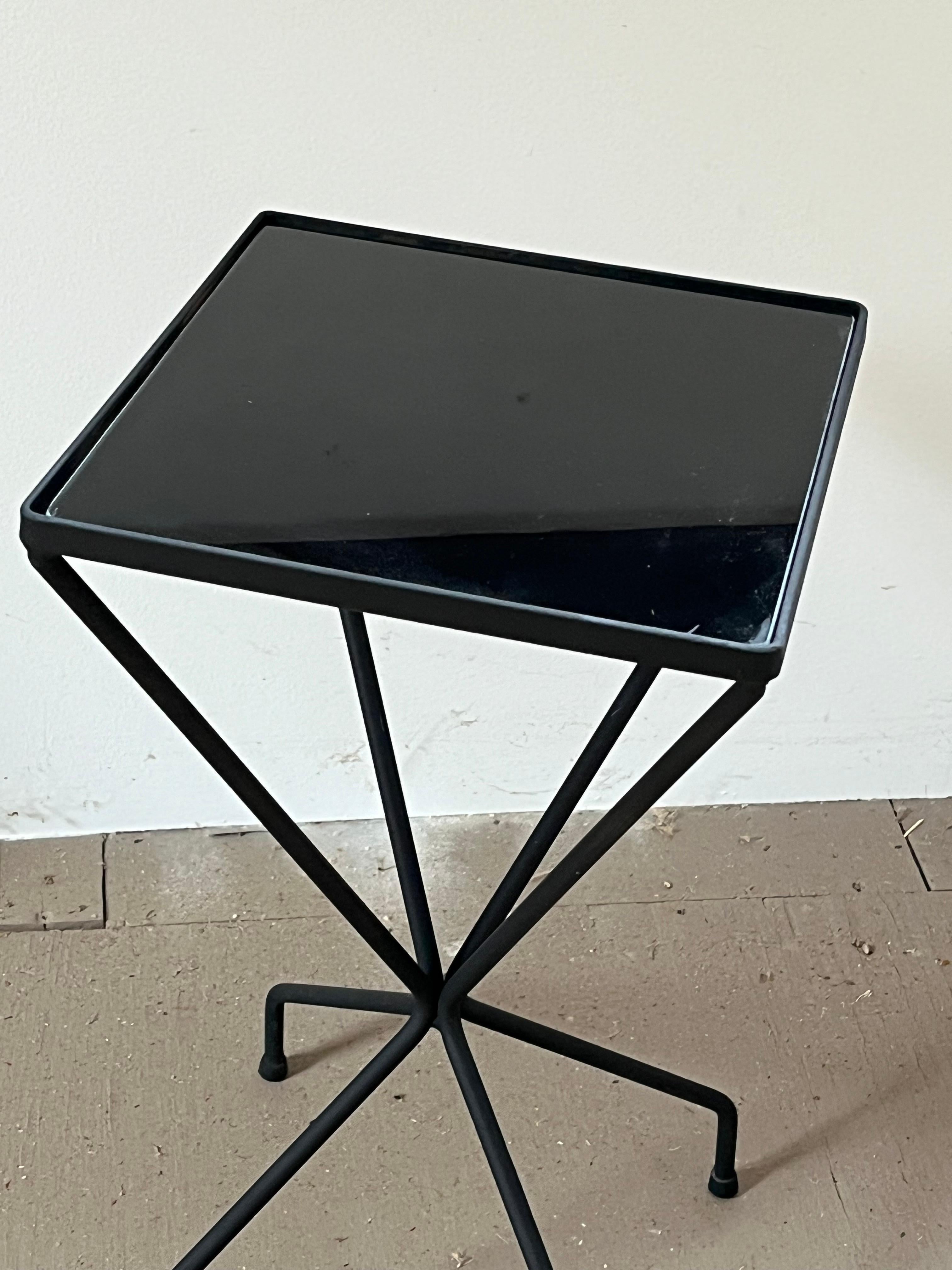 A charming little side table in black painted steel with inset black glass mirror, mid 1950’s in the style of Mathieu Mategot. 