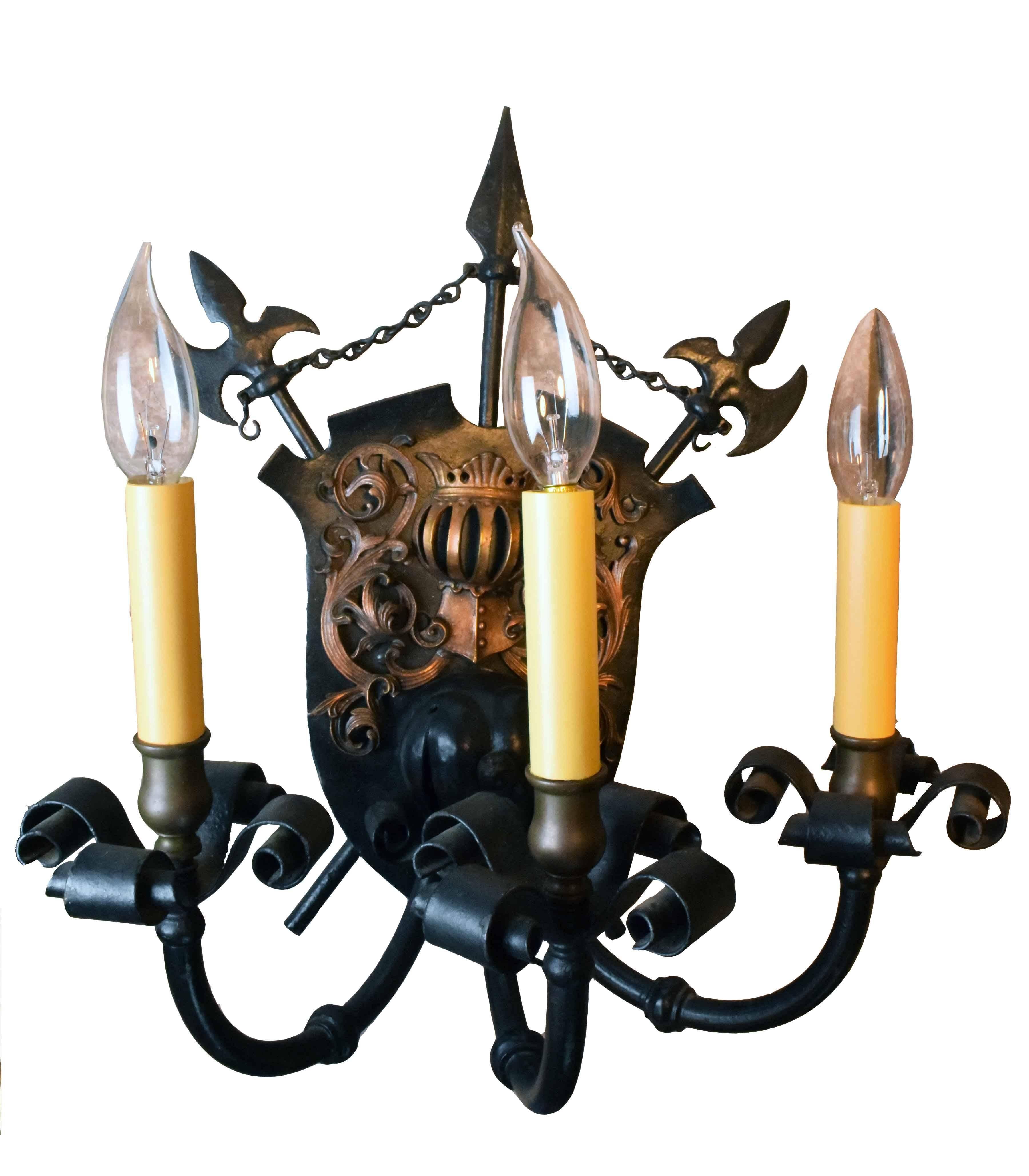 This iron and brass three-arm knight sconce looks like it was pulled right out of a medieval castle! A shield back plate creates a dramatic backdrop for the fixture’s three candles,

 

circa 1930
Finish: Original
Country of origin: USA
Three