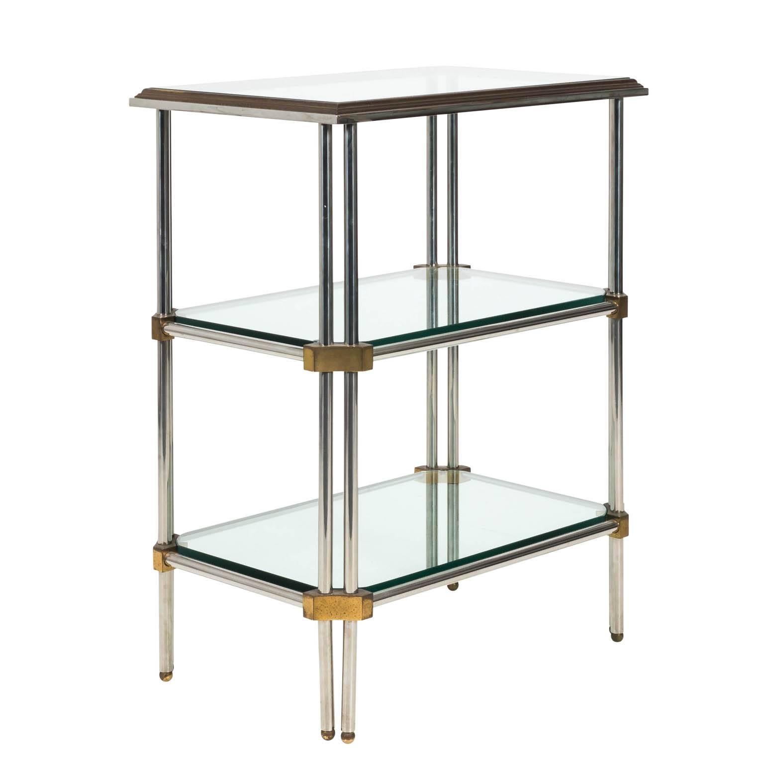 Hollywood Regency style three tier étagère with glass tops and brass accents in a polished finish with some minor scratchers and wear, circa late 20th century.
 
