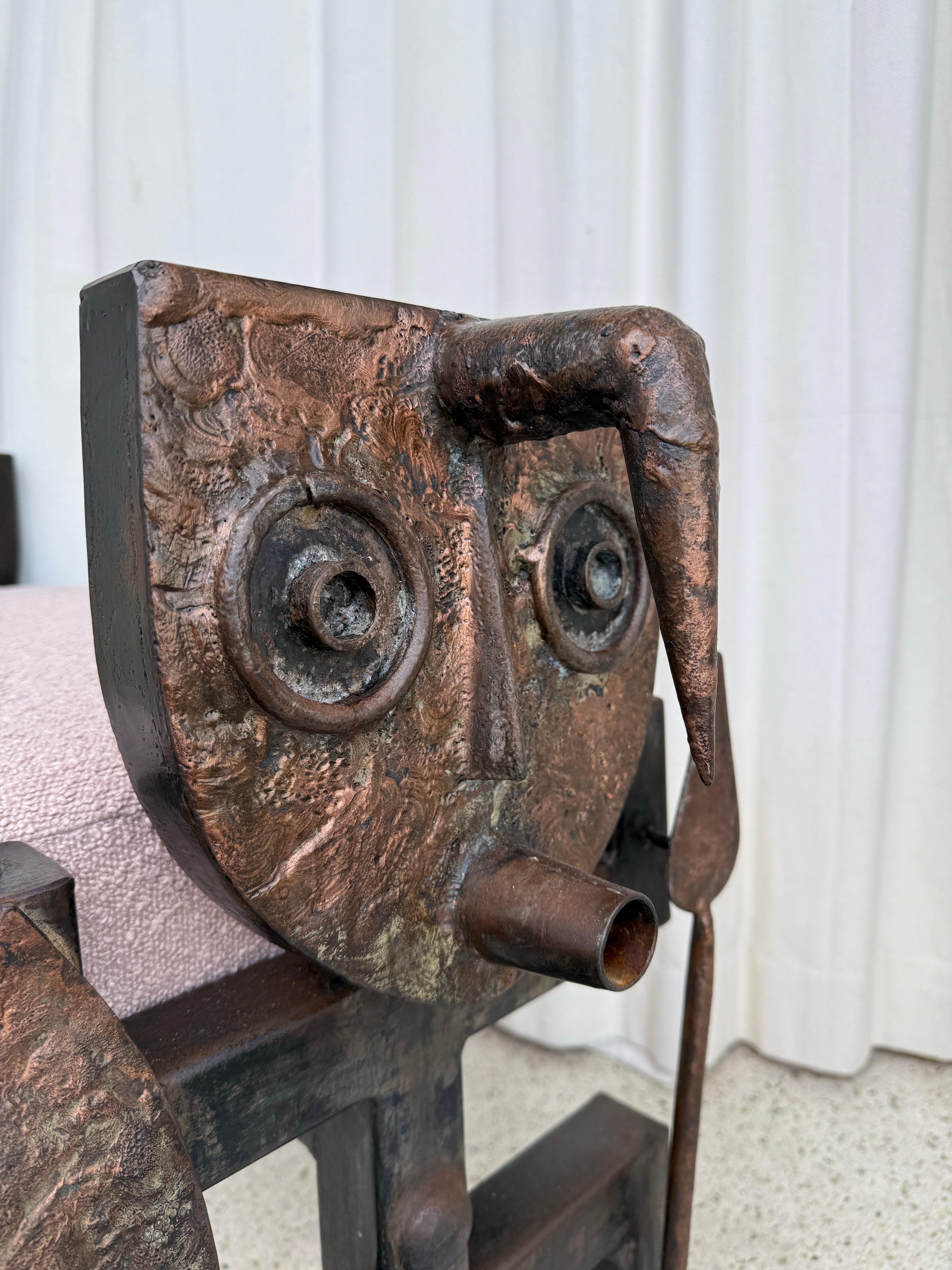 Very unique tribal style bronze bench with two sides depicting a warrior.  It is heavy and solid with a perfectly finished soft pink boucle fabric.  Pretty from ALL sides.