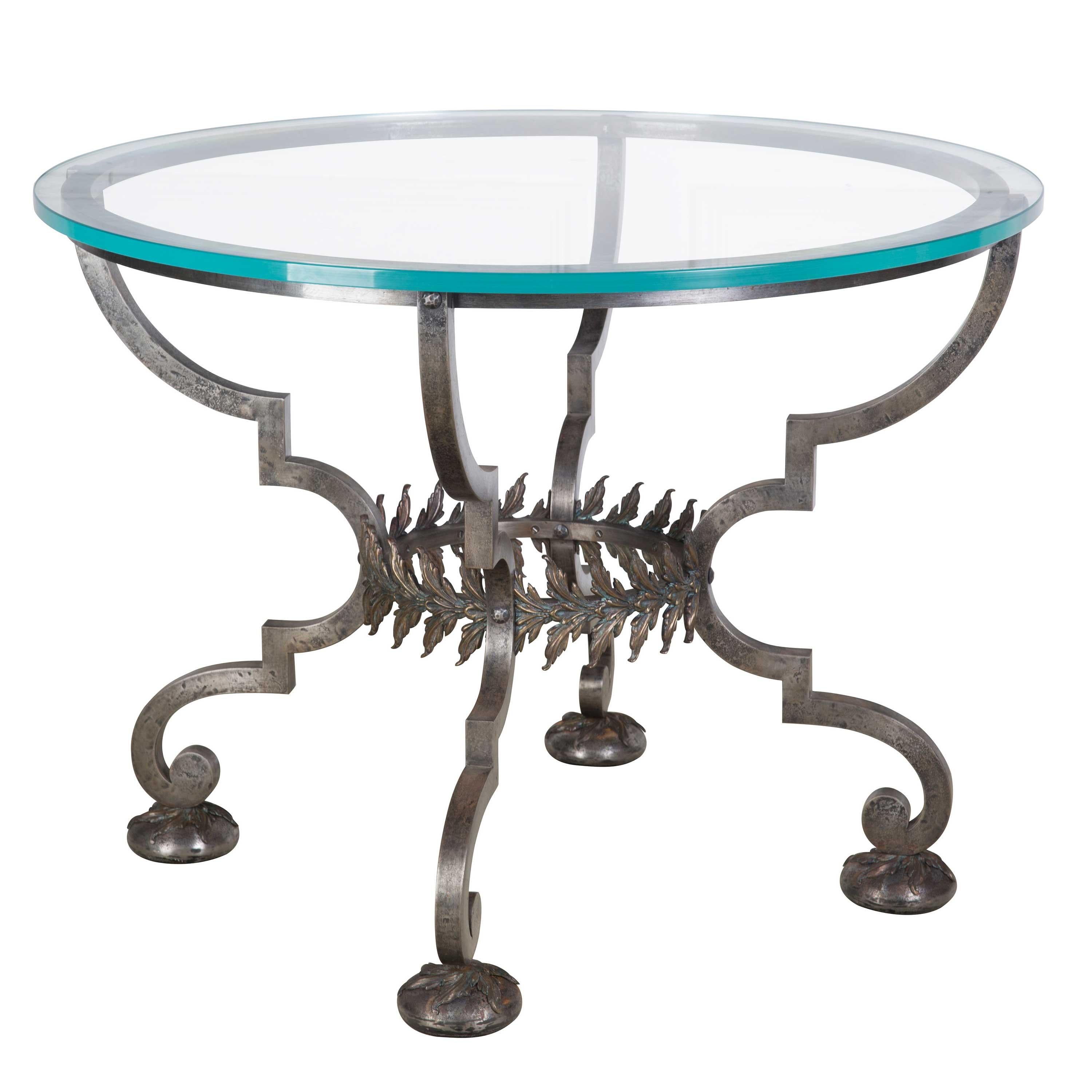 An iron and bronze centre table in the style of Poliert. An exceptionally rare and stunning piece. Later glass top, France, circa 1950.