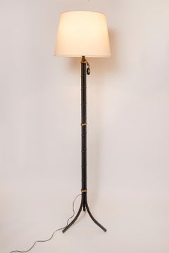 Iron and bronze pair of floor lamps. France, circa 1940.