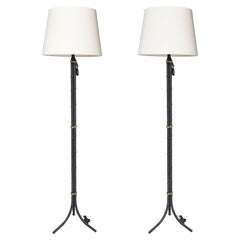 Iron and bronze pair of floor lamps. France, circa 1940.