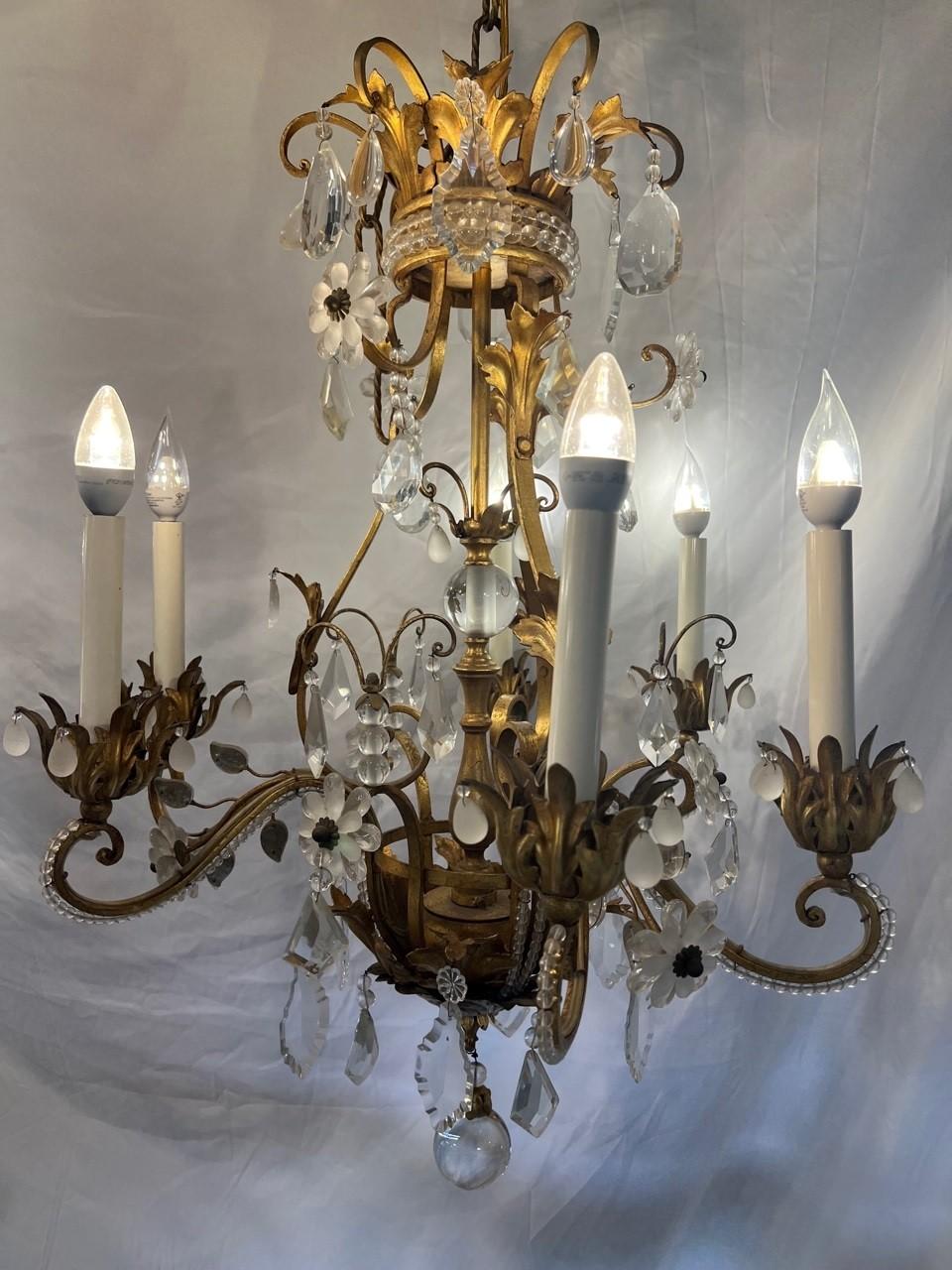 Gorgeous Italian six arm crystal and iron chandelier with antique brass finish very good quality. This is a beautiful chandelier with crystal flowers and hand beaded crystal on each arm. Its a great size that would look amazing over a dining room