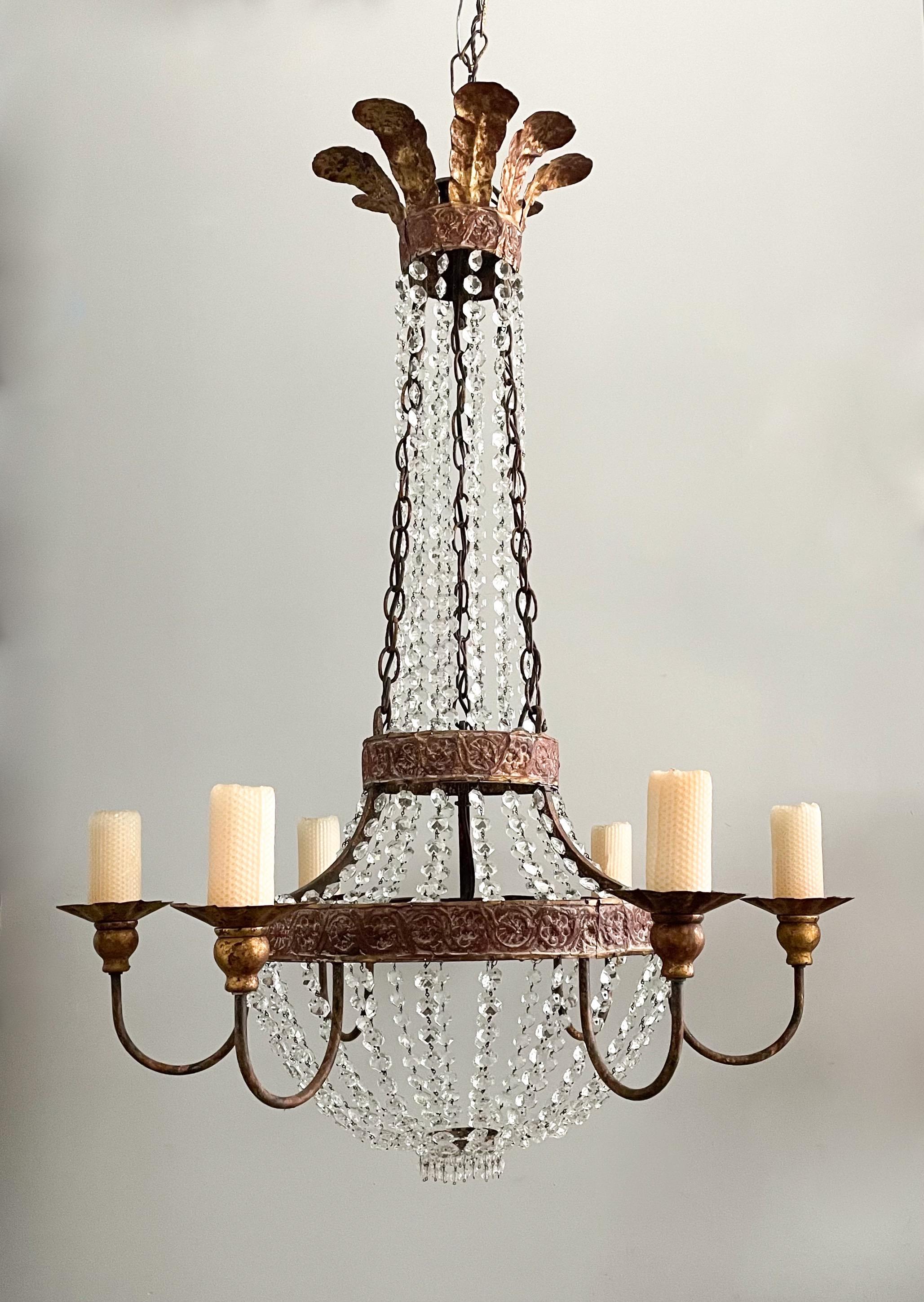 Graceful, iron and crystal chandelier in the Empire style by Niermann Weeks.

The chandelier features a painted iron repoussé frame with a gilded plume crown at top and is decorated with faceted crystal beads. 

The chandelier is wired and in