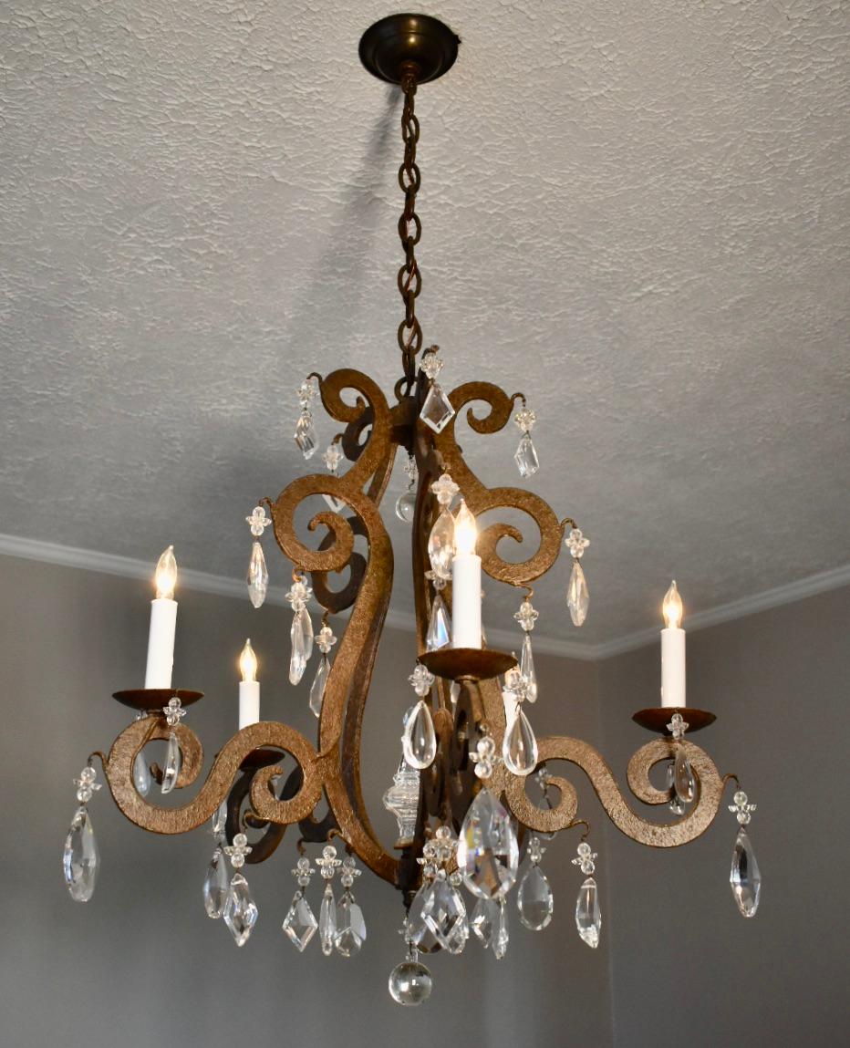 French style iron chandelier with 5 scrolled arms decorated with crystal pendalogues. Possibly a custom piece, maker unknown but high end fixture the quality of Niermann Weeks, Ferrante, Dennis & Leen in an oxidized iron paint finish. Wired for US
