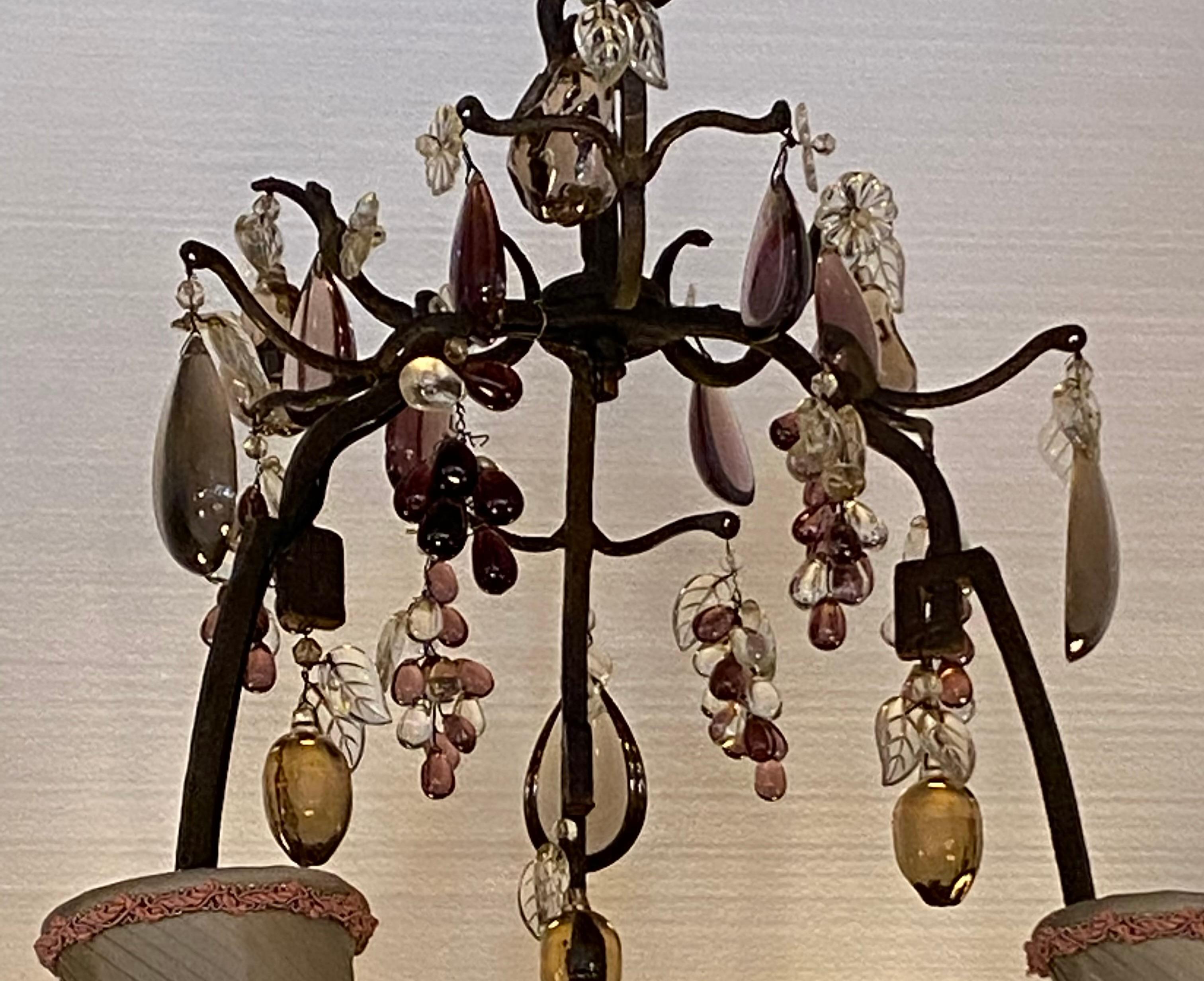 Iron and gilt tole with six lights; having grape, apple, pears, and clear drops. Main colors are clear and light brown. Chandelier comes with 6 - 4