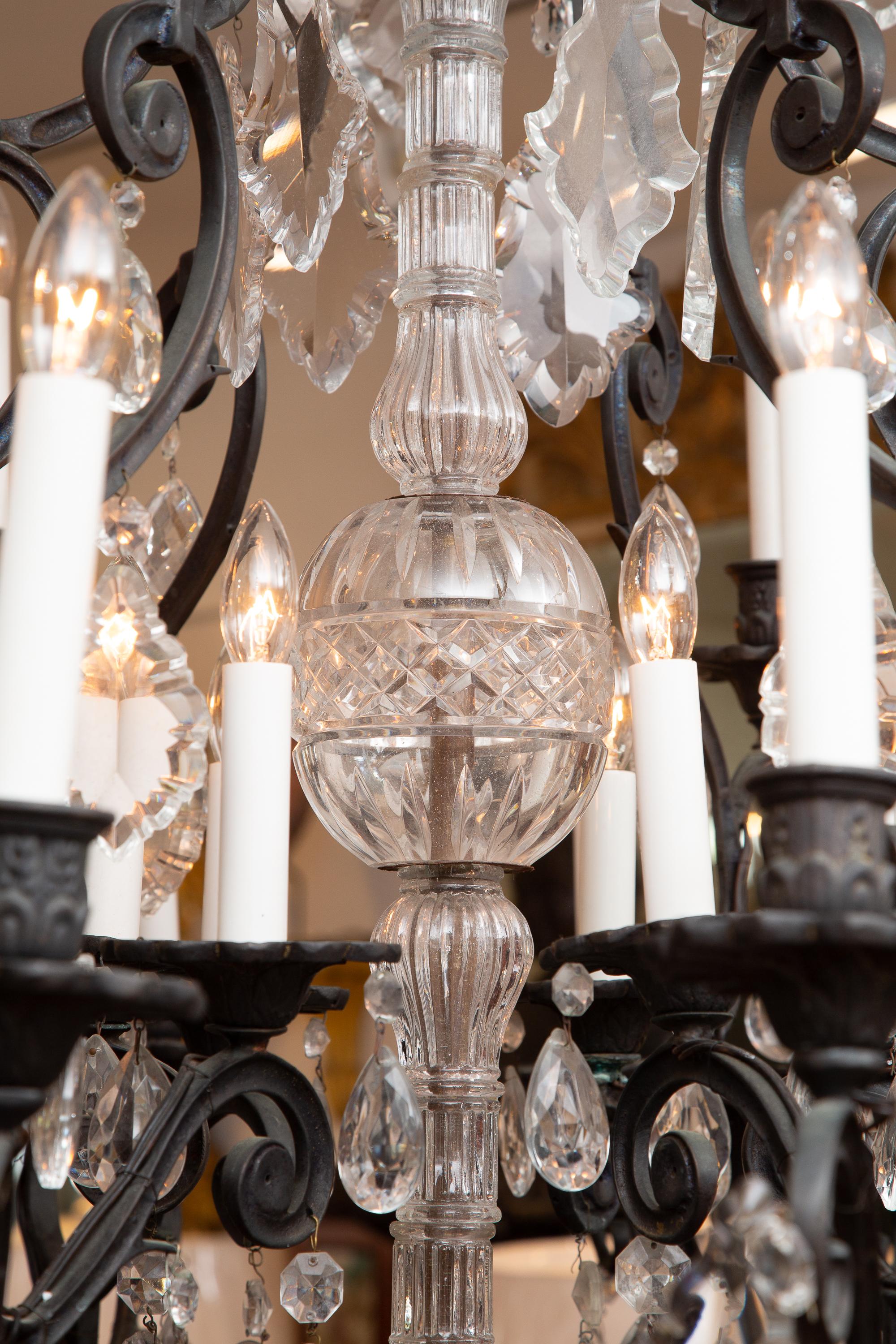 This is a large scale 30 light iron birdcage style chandelier with overall cut crystals and prisms.