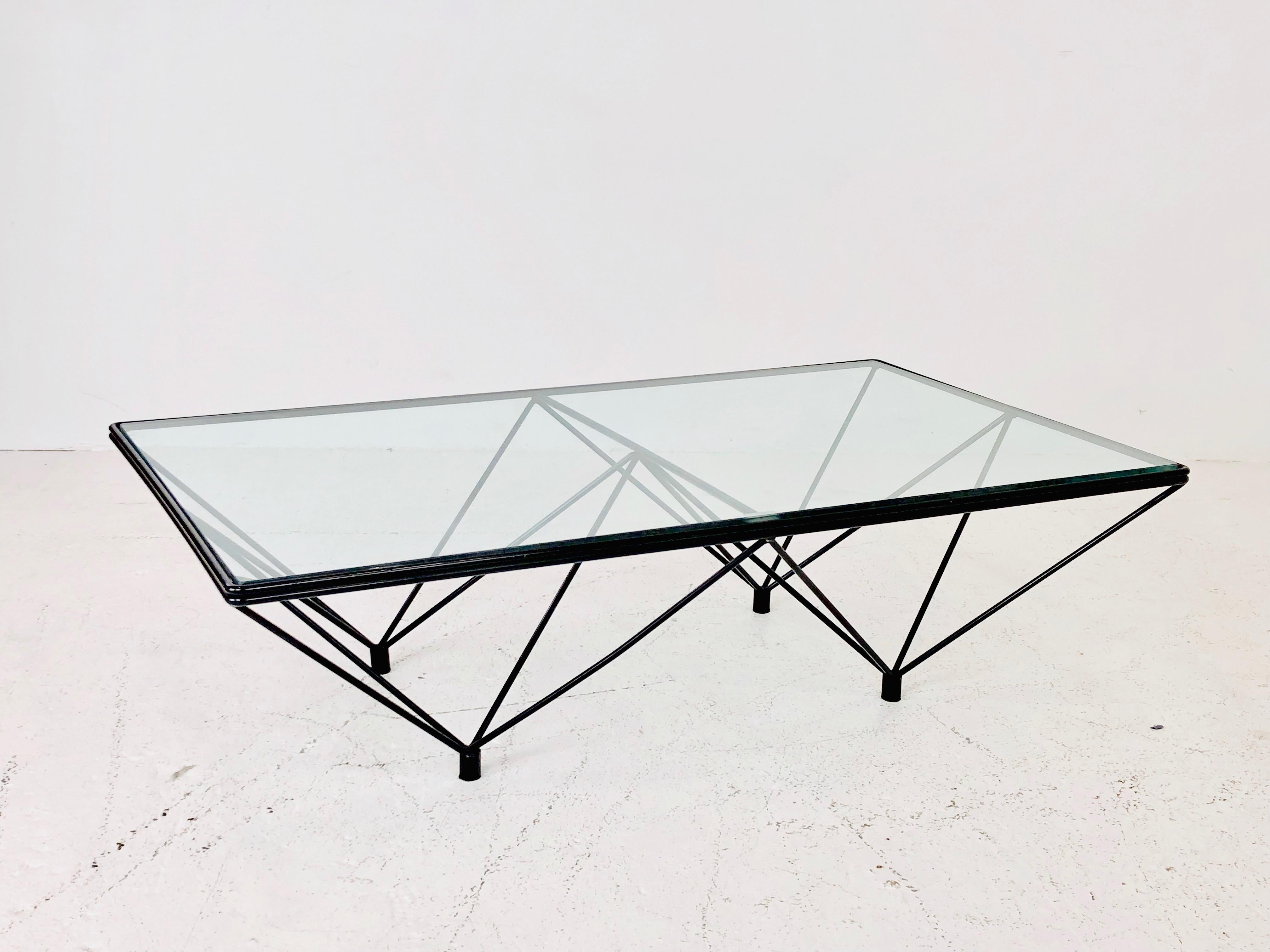 Black iron and glass coffee table in the style of Paolo Piva. Table is in good vintage condition with some wear on glass and metal from age and use.

Dimensions:
47.5 W x 28 D x 13 T.