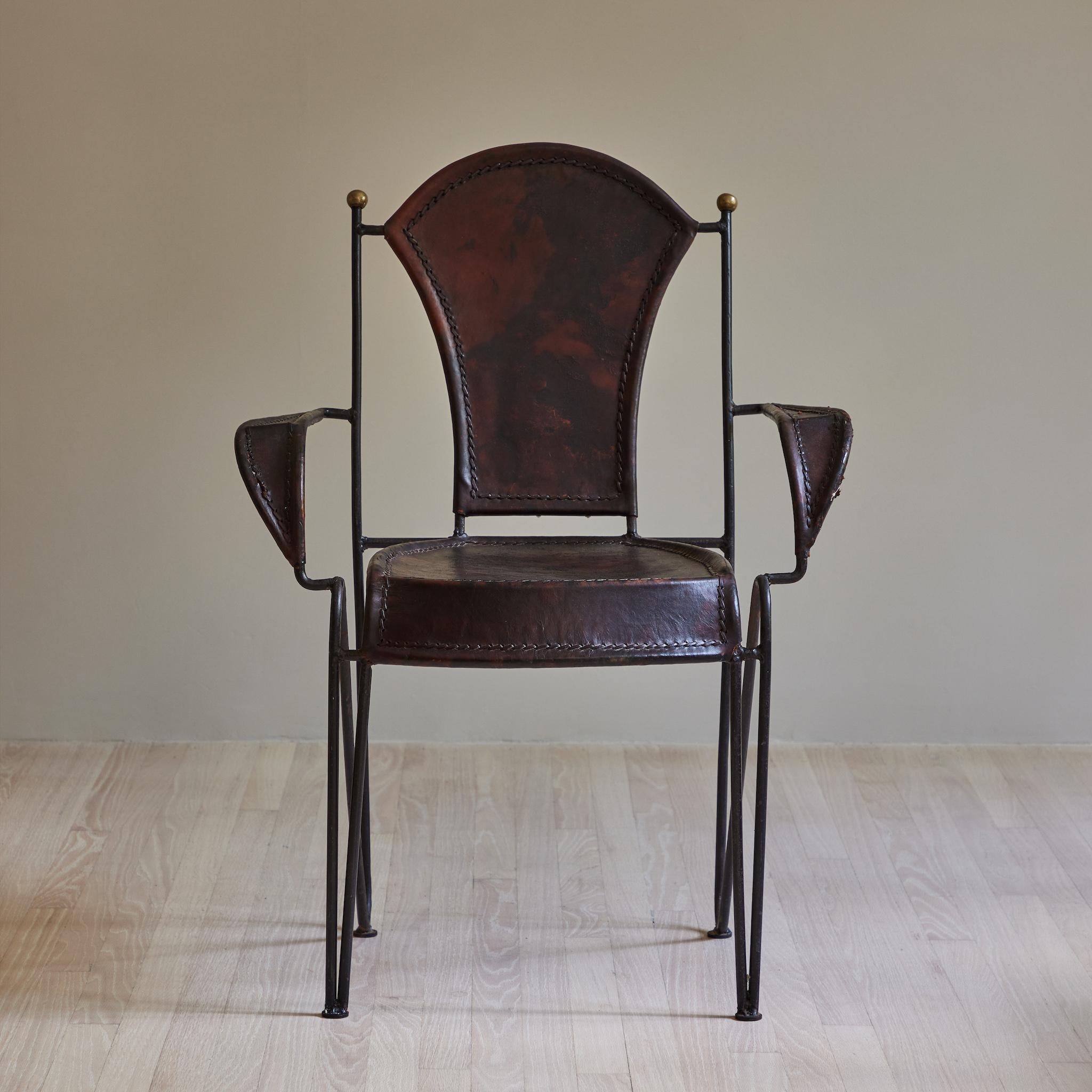 Iron armchair with leather seat and back.
