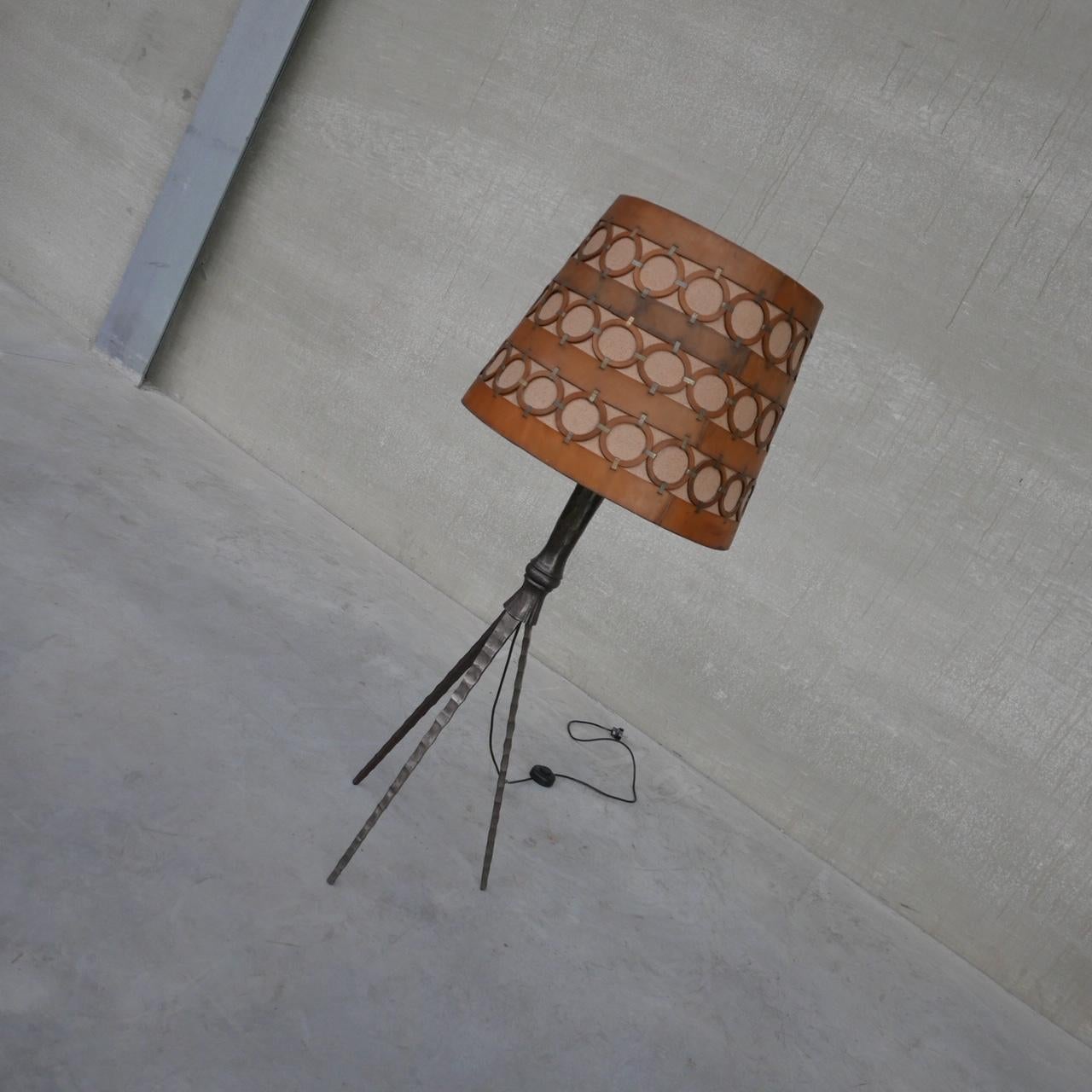 An iron and leather floor lamp. 

Spain, c1950s. 

A remarkable hand crafted leather and brass shade sits over a good quality iron tripod floor lamp. 

3/4 height. 

Since re-wired and PAT tested.

Location: Belgium Gallery.