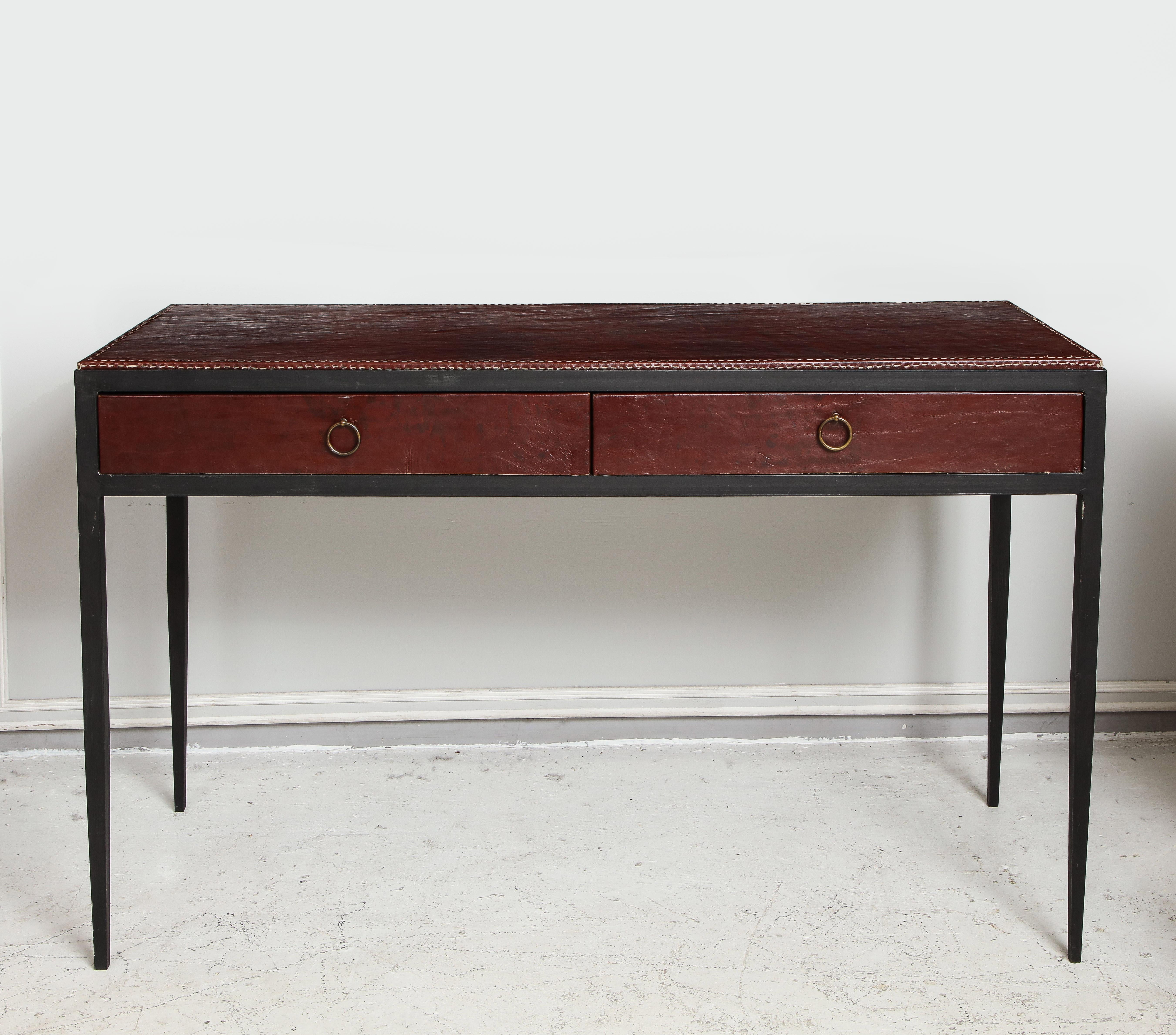 Iron and leather desk/ console on tapered legs in the Jean Michel Frank manner.