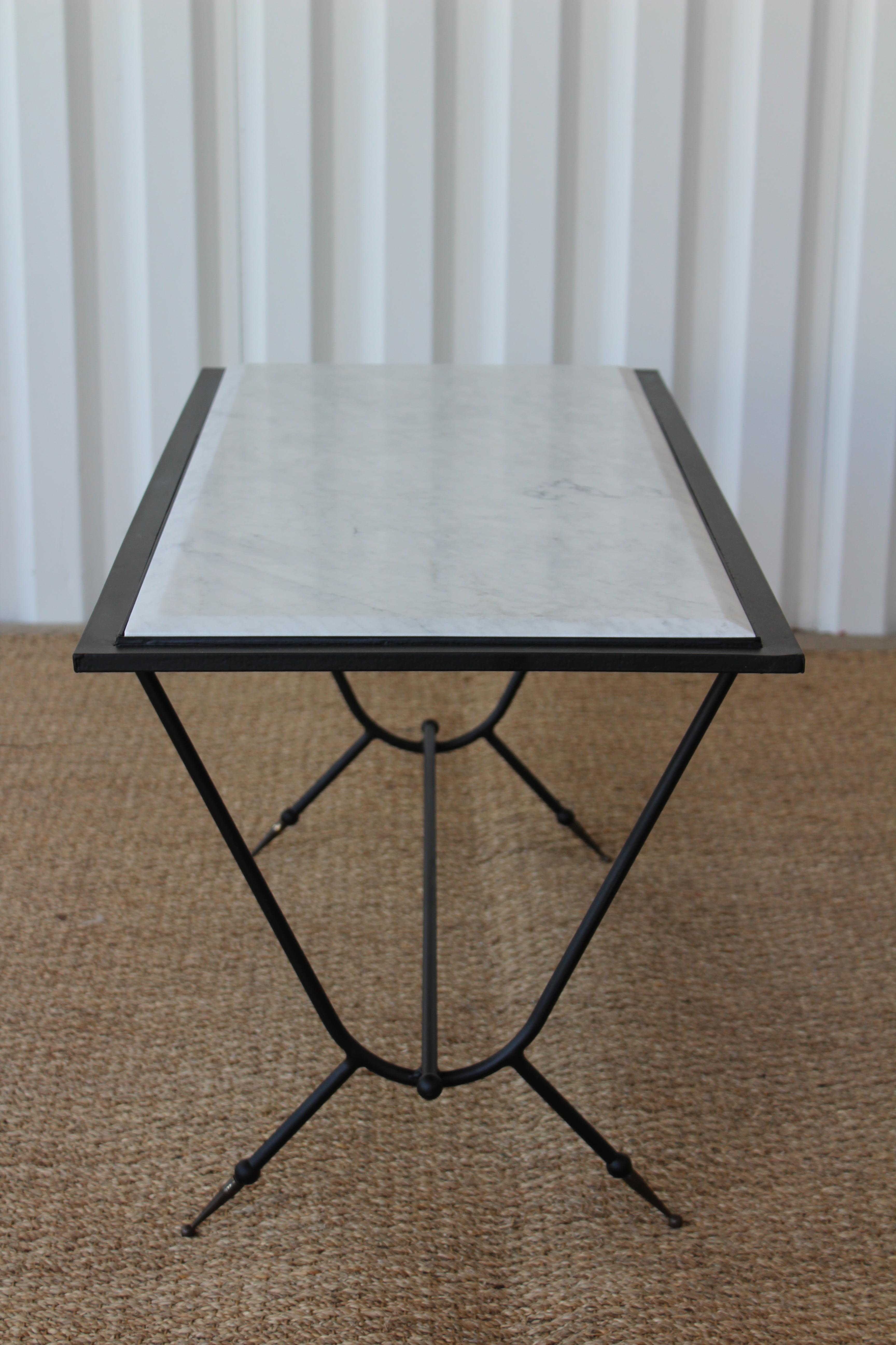 Vintage 1950s Italian coffee table, made of iron and marble, with solid brass sabot feet. The table has been restored with a newly powdercoated iron frame and a new marble surface. The brass sabot feet have been left with a nicely aged brass patina.