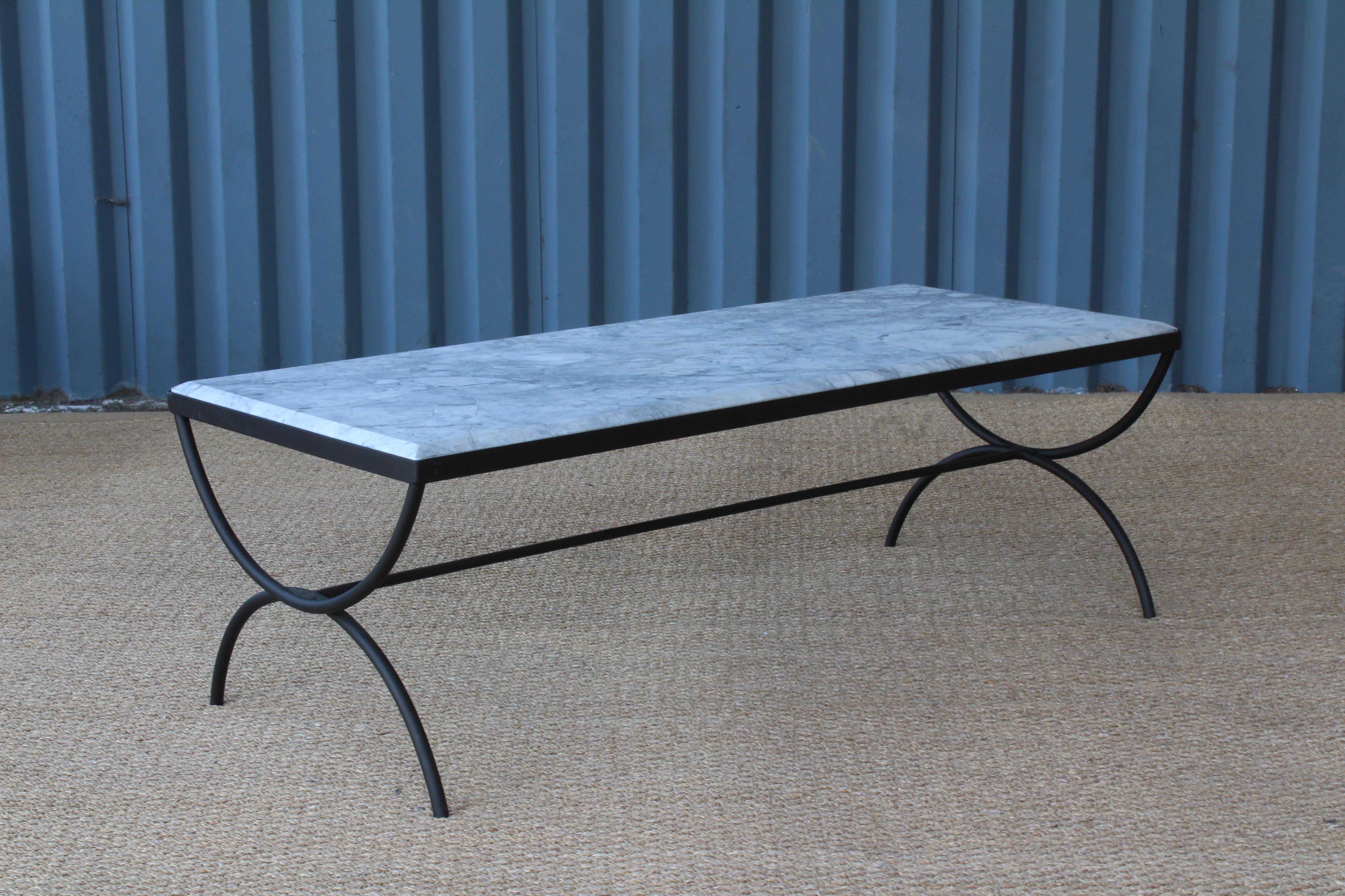 Iron framed coffee table with a new marble top. Iron frame has been recently powder coated. The marble top is new and cut to fit with a beautiful beveled edge. Suitable for indoor or outdoor use.