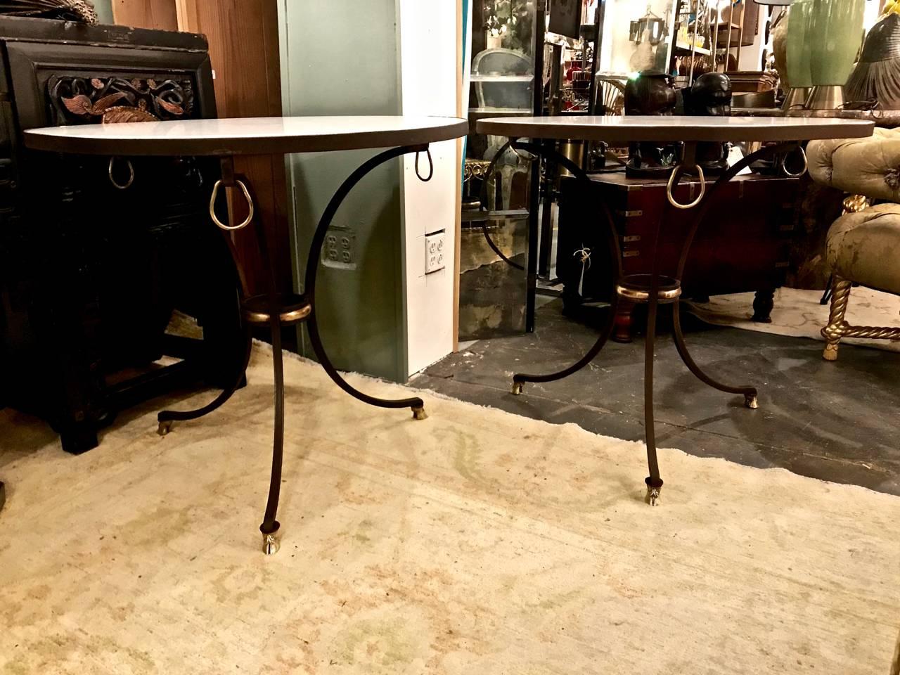 This is a wonderful pair of circa 1970s-1980s neoclassical Jansen-style forged iron, marble and brass gueridons or side tables. The tables are beautifully detailed in brass and Carrara marble.